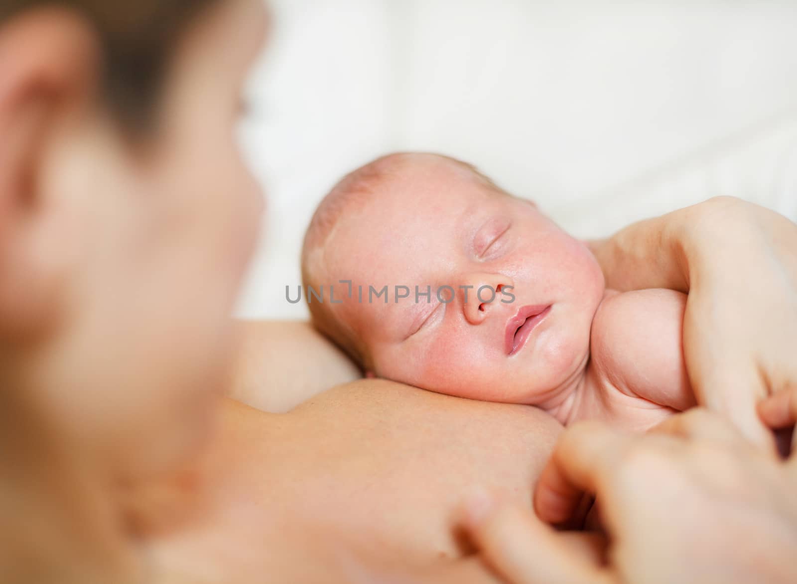 Close Up of sleeping newborn baby Aged 11 Days on mother's chest