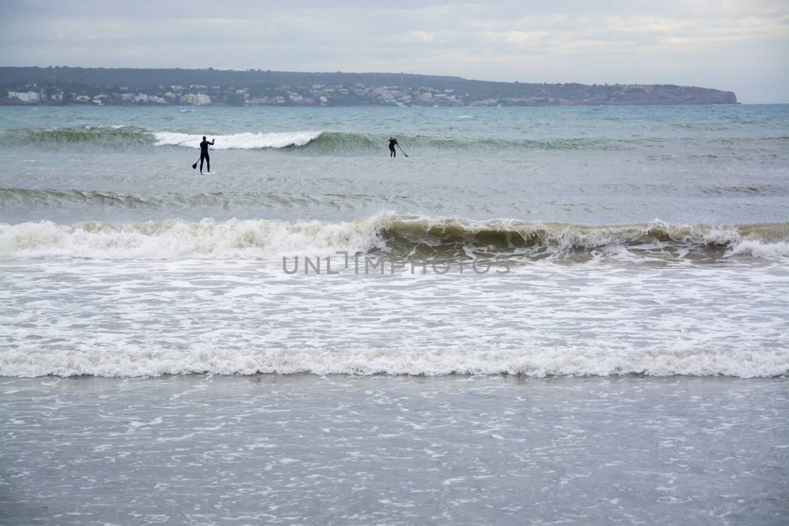 Paddle Surfers Large Waves, Playa de Palma, Mallorca, Balearic islands, Spain in November.