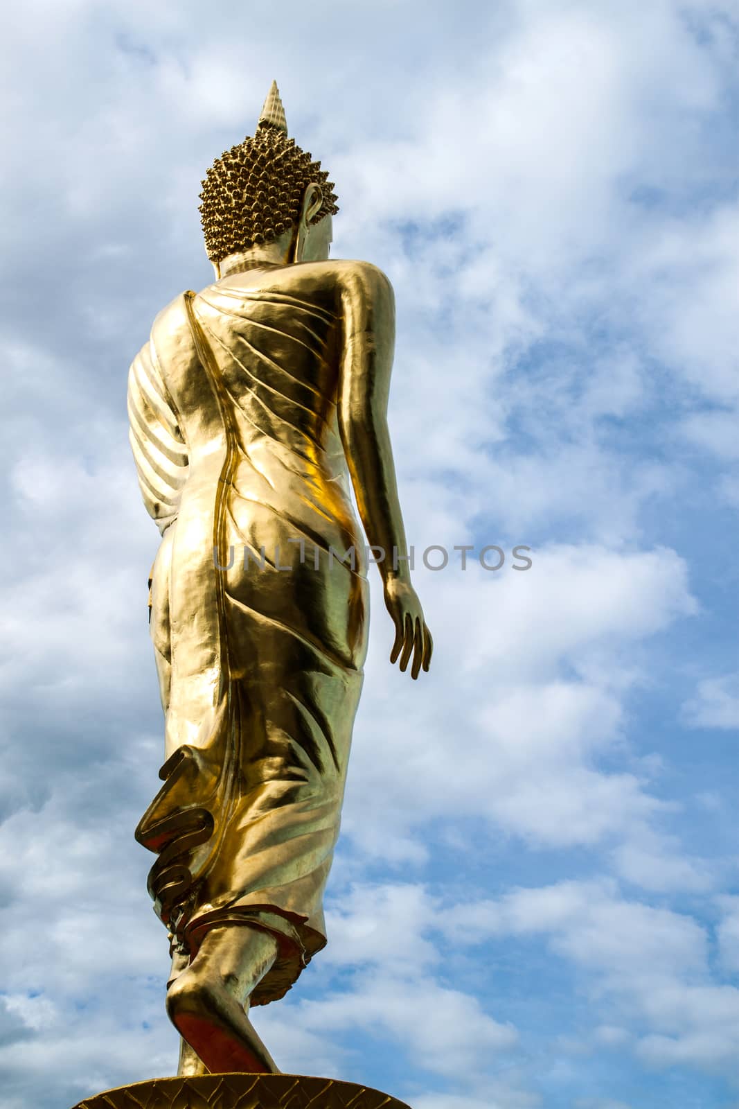 Buddha standing on a mountain Wat Phra That Khao Noi, Nan by kannapon