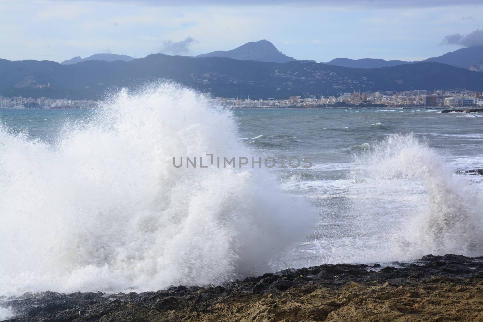 Large Wave Palma Bay. Fresh foamy wave crashing onshore. Cala Estancia, Mallorca, Balearic islands, Spain in November.