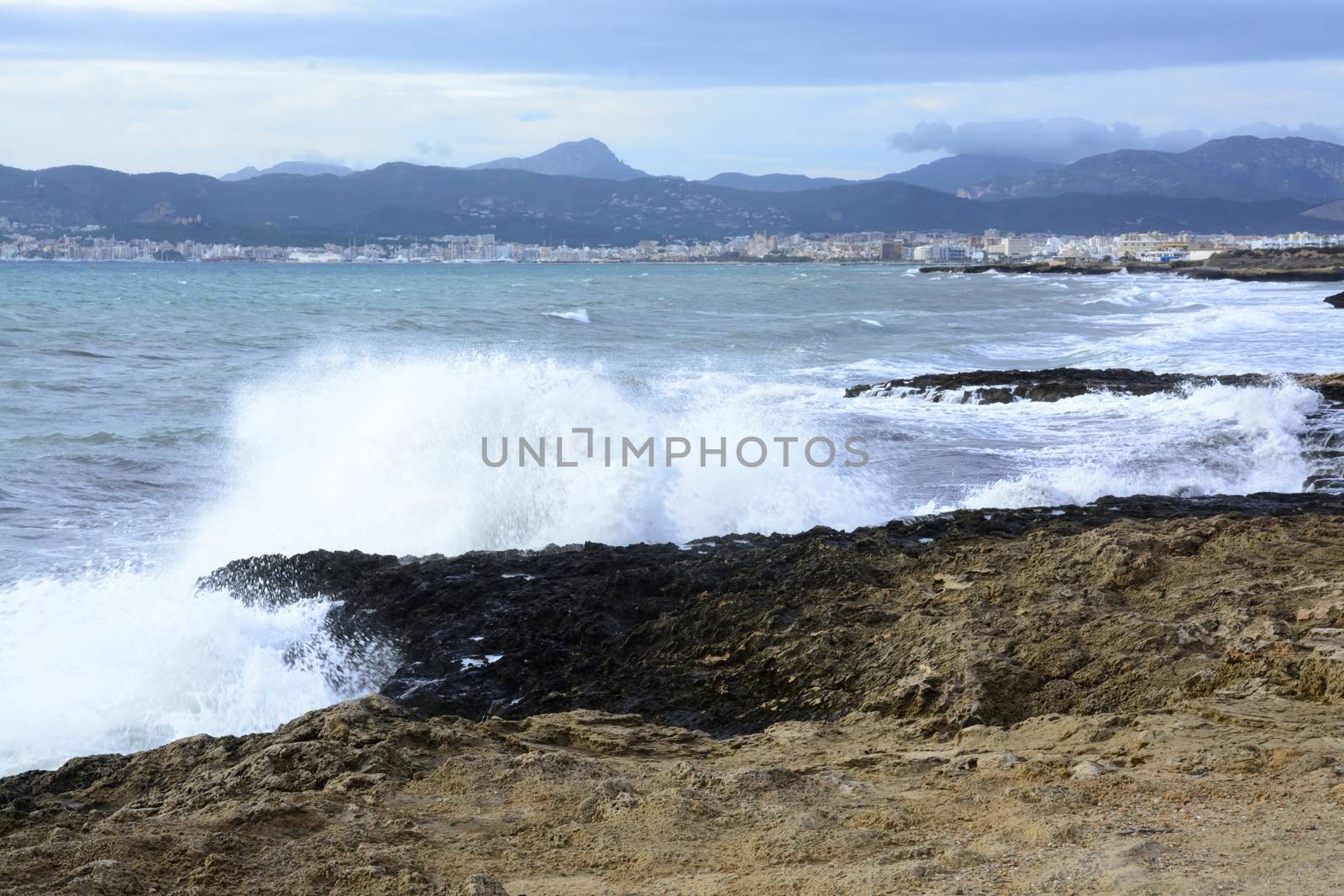 Wave Palma Bay. Fresh foamy wave crashing onshore. Cala Estancia, Mallorca, Balearic islands, Spain in November.