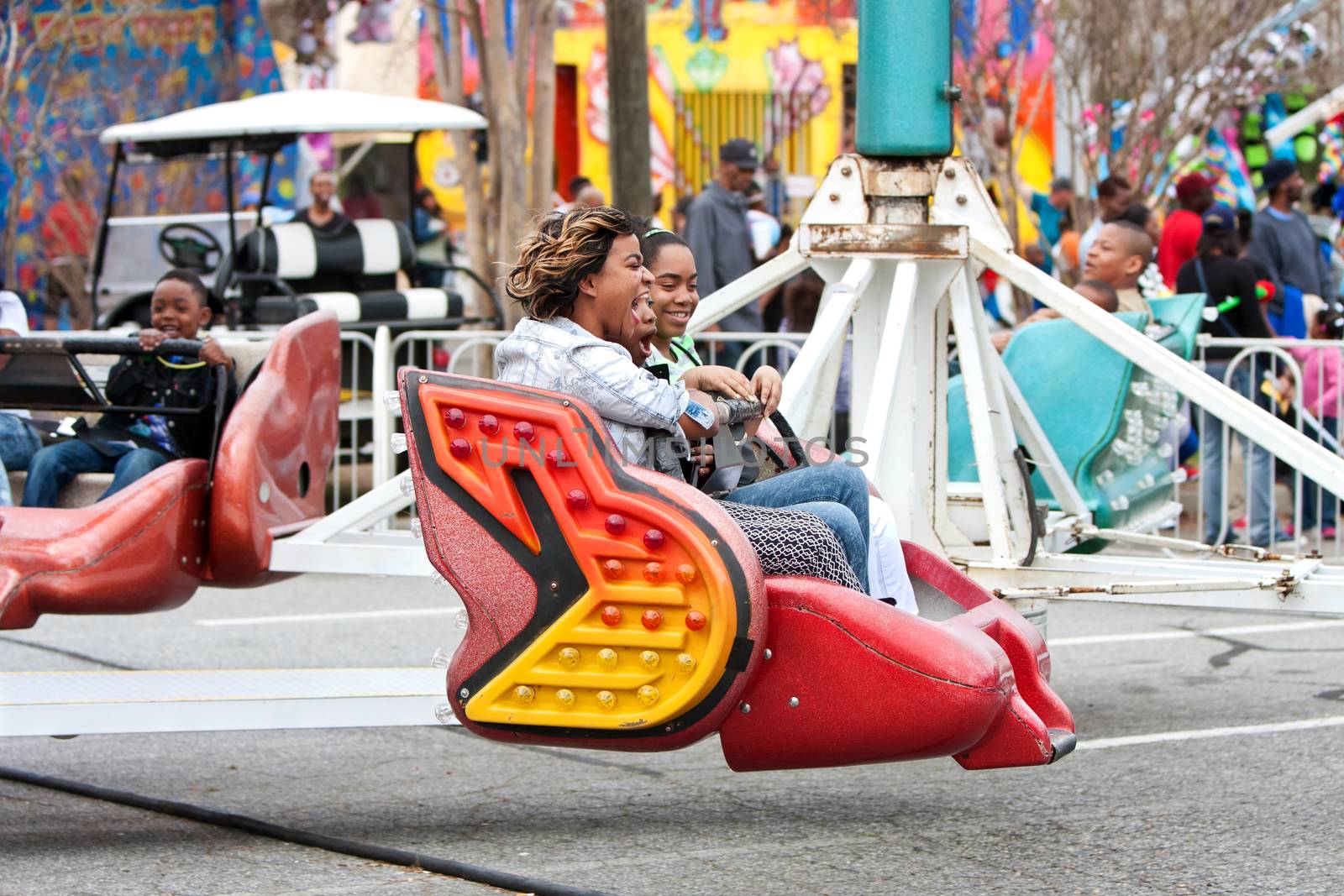 Atlanta, GA, USA - March 15, 2014:  Women laugh while riding a fast-moving carnival ride at the annual Atlanta Fair.