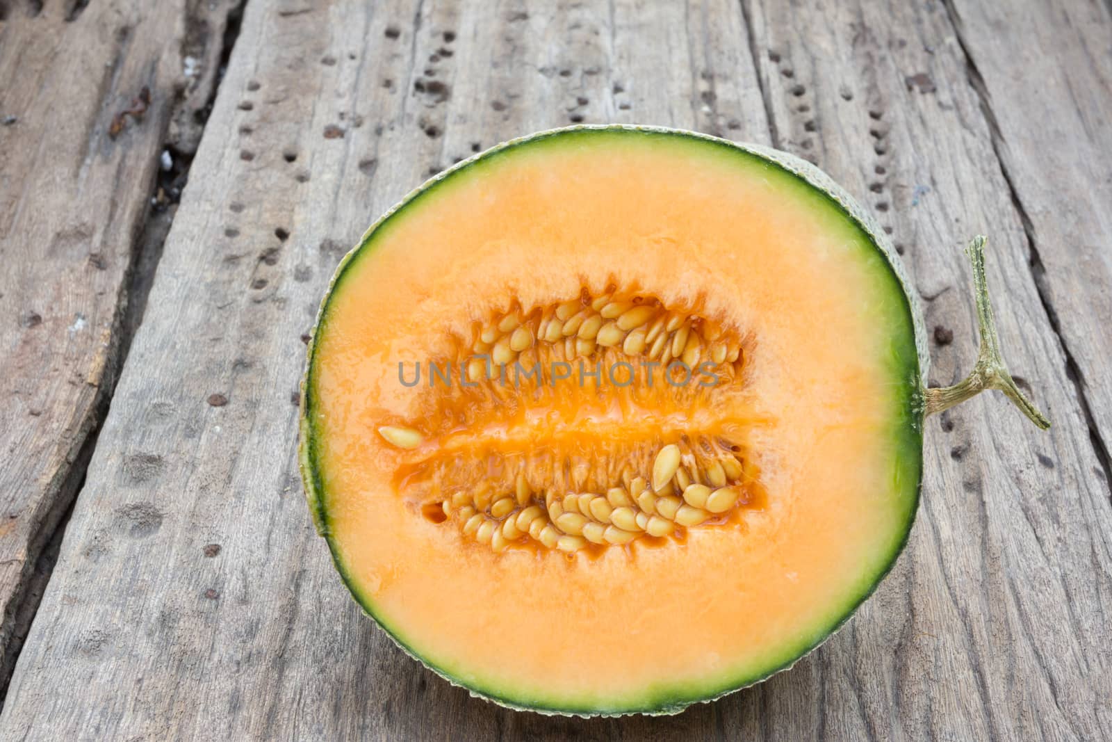 cantaloupe melon slices on old wood background, Close up