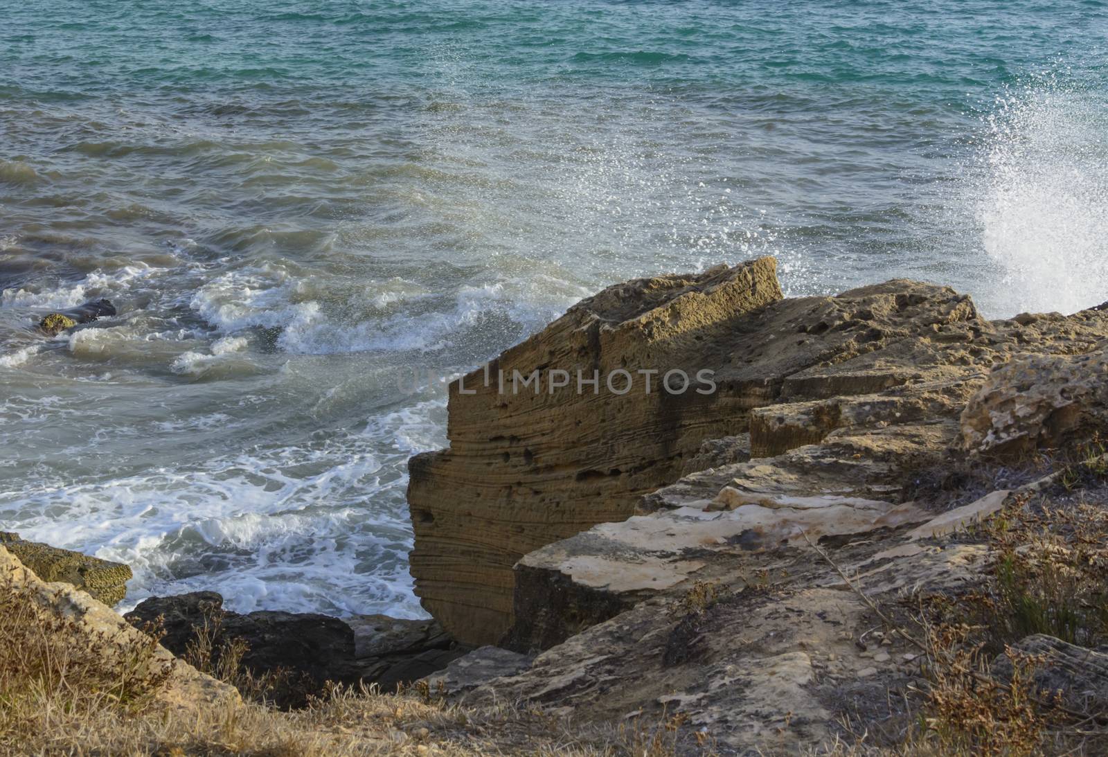 Limestone Cliff Sea Spray at Ses Covetes, Mallorca, Balearic islands, Spain in October.