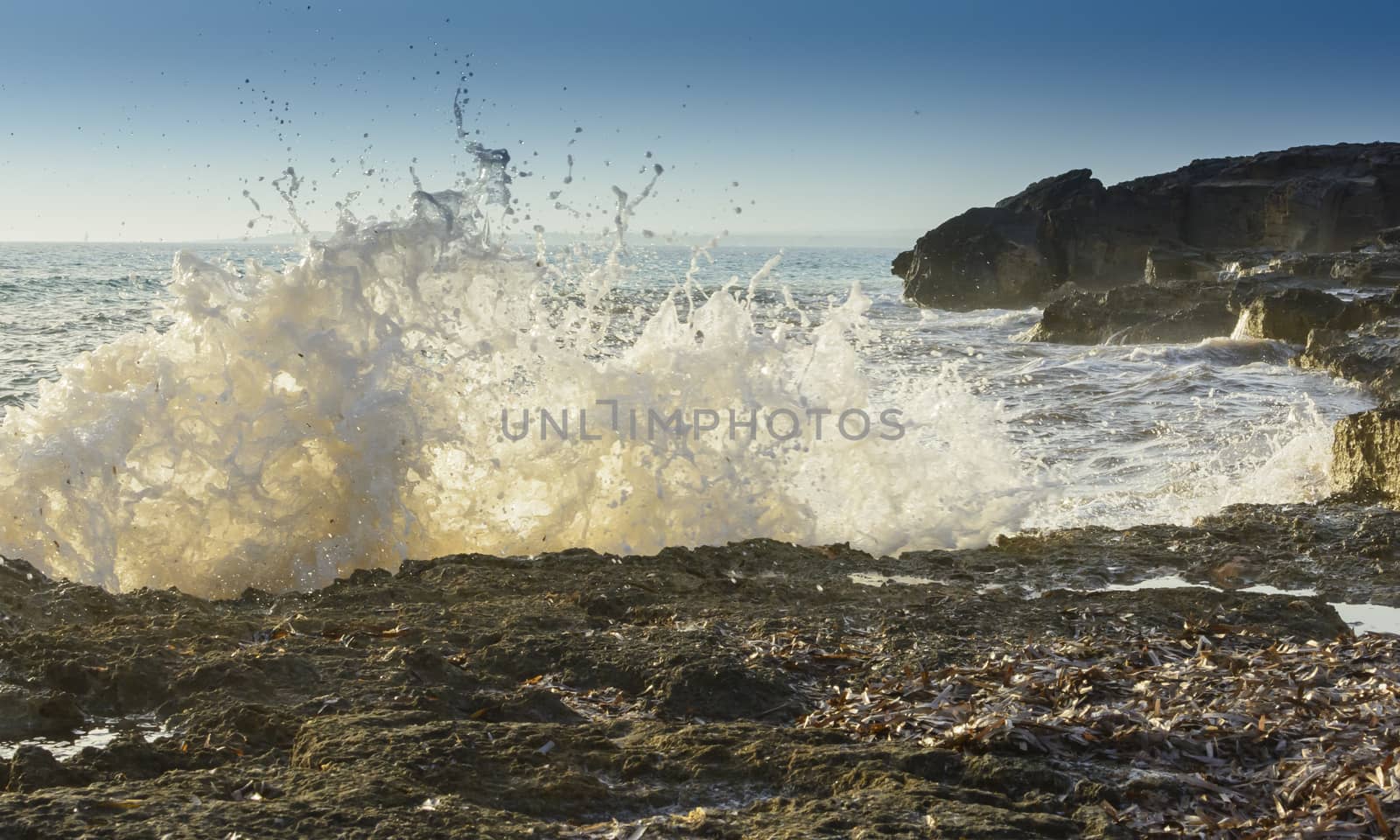 Breaking wave closeup in Ses Covetes, Mallorca, Balearic islands, Spain in October.