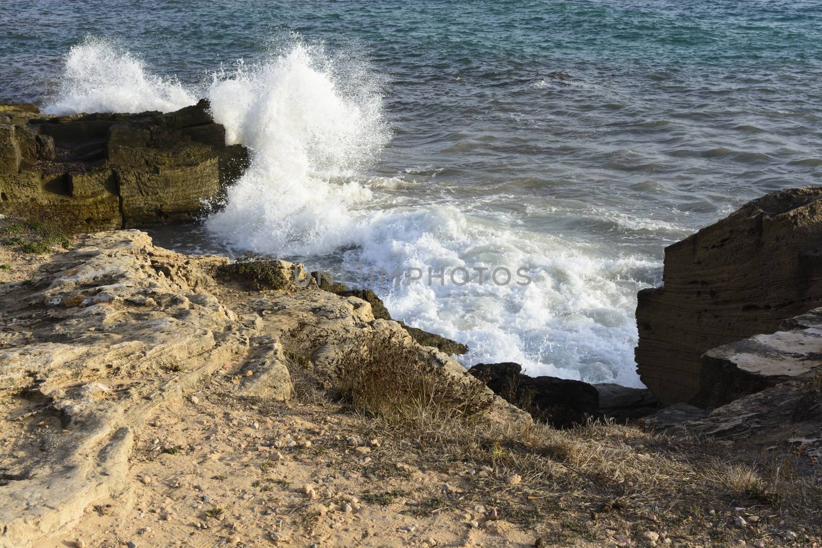 Crashing Wave Sea Foam at Ses Covetes, Mallorca, Balearic islands, Spain.