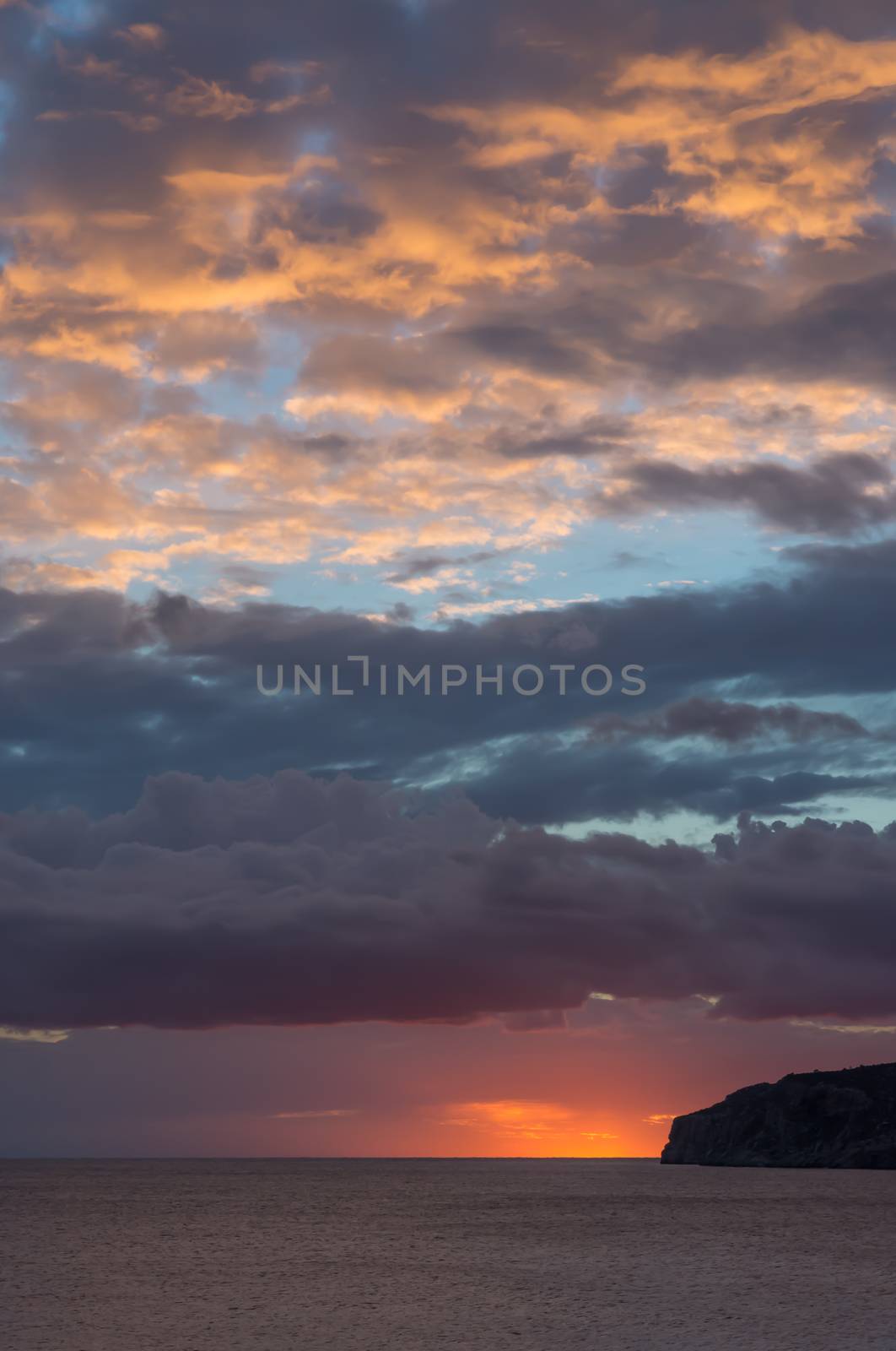 Orange blue skyscape after storm in October. Sant Elm, Mallorca, Balearic islands, Spain.