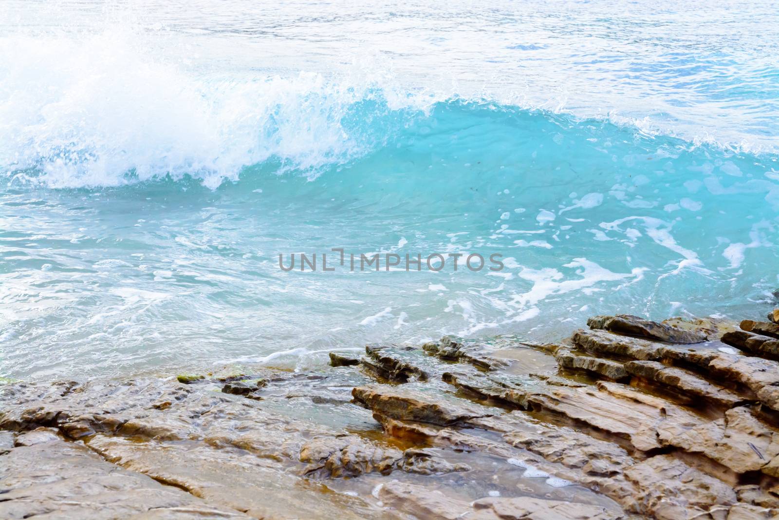 Clear turquoise wave on rocks in Sant Elm, Majorca.