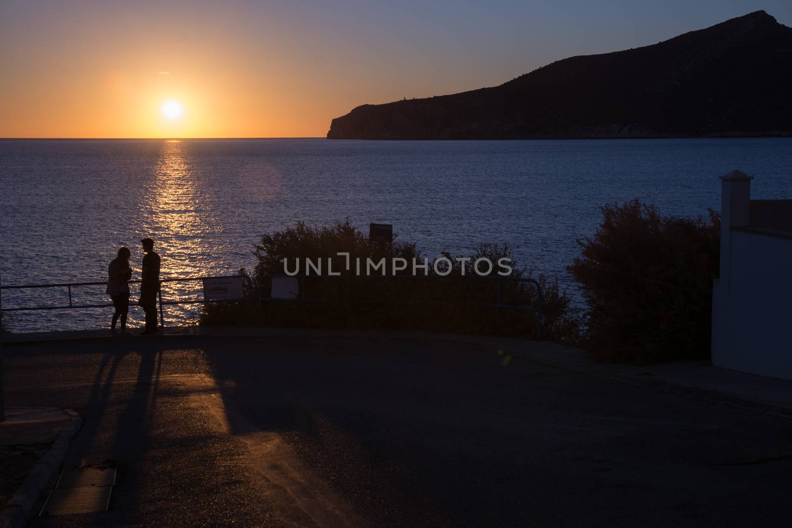 Mediterranean sunset couple. Couple enjoying a romantic sunset. Mallorca, Balearic islands, Spain.