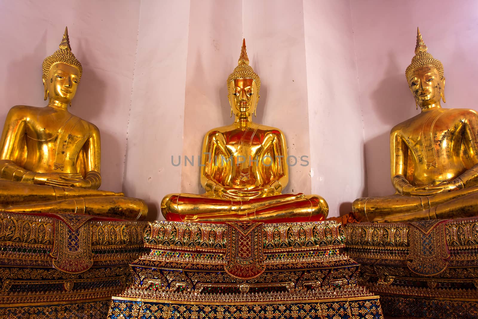 Three golden buddha statues in Thailand