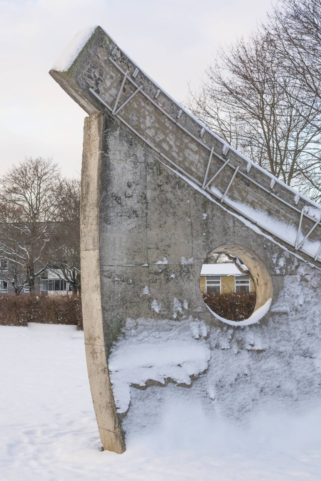 Winter sculpture detail in snow with roman numbers Five and Six - The Sundial by Sven Goran Holmstrom, Solursparken, Vallingby, Stockholm, Sweden.