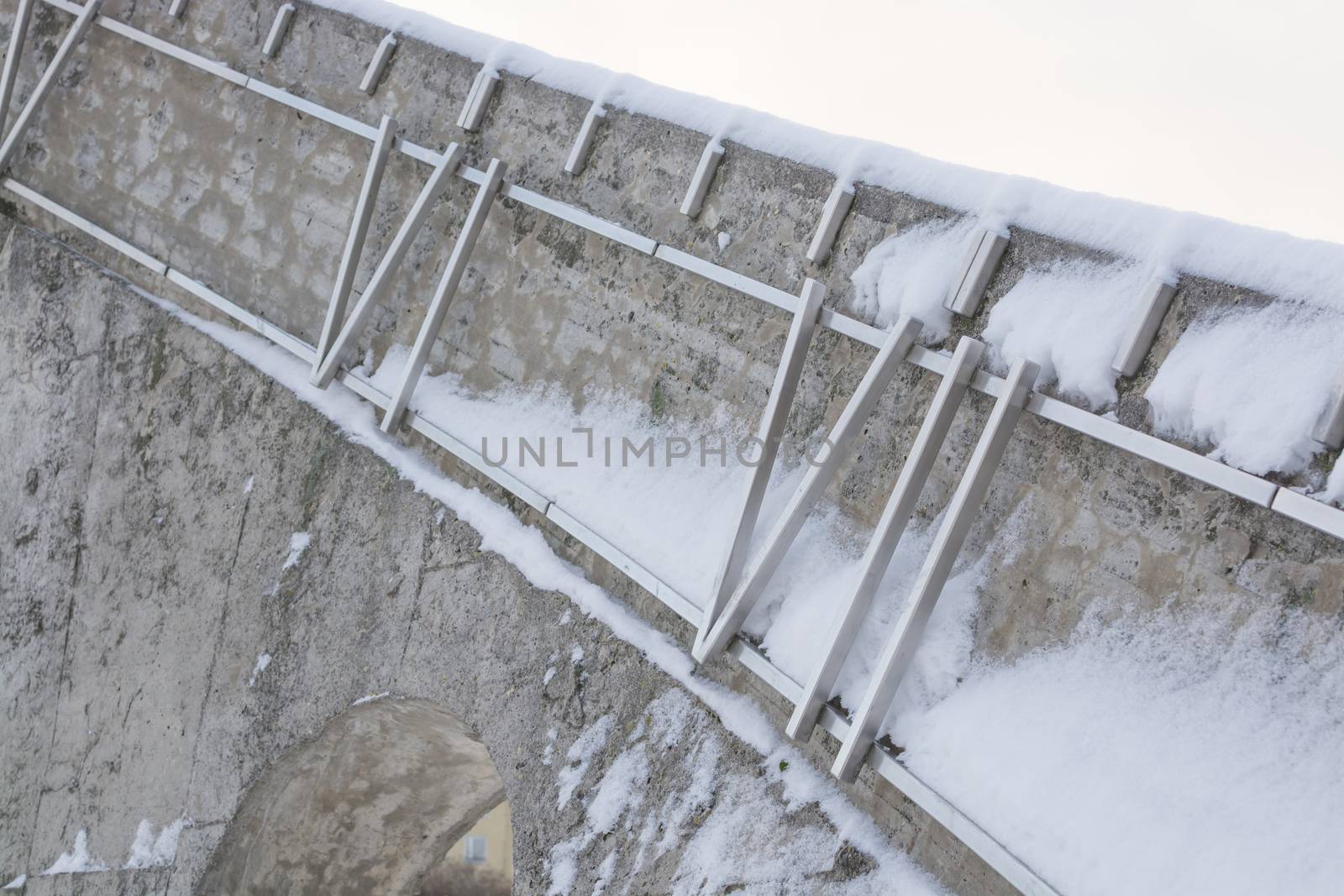 Winter sculpture detail with roman numbers six and seven in snow - The Sundial by Sven Goran Holmstrom, Solursparken, Vallingby, Stockholm, Sweden.