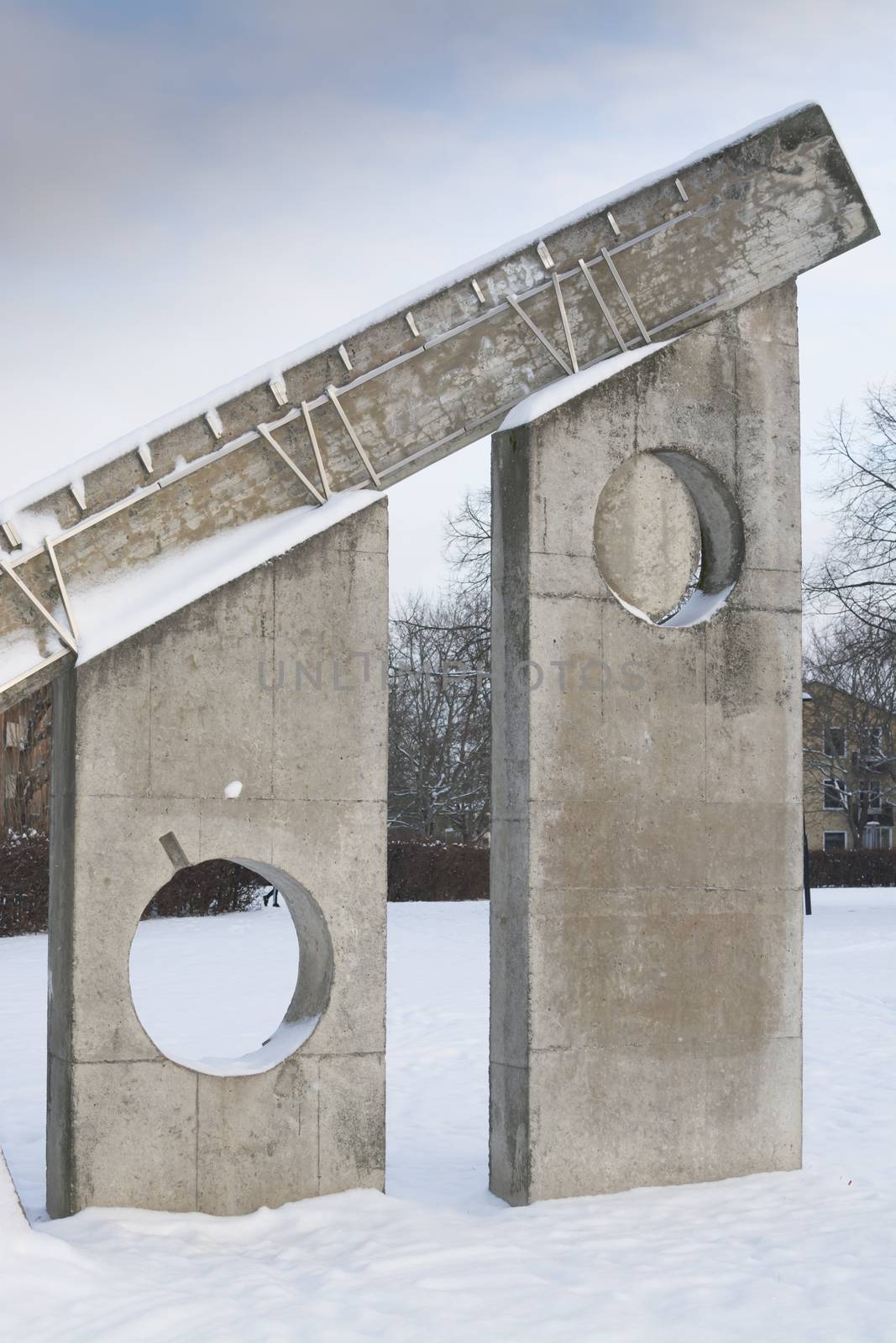 Winter sculpture detail in snow - with roman numbers six and seven - The Sundial by Sven Goran Holmstrom, Solursparken, Vallingby, Stockholm, Sweden.