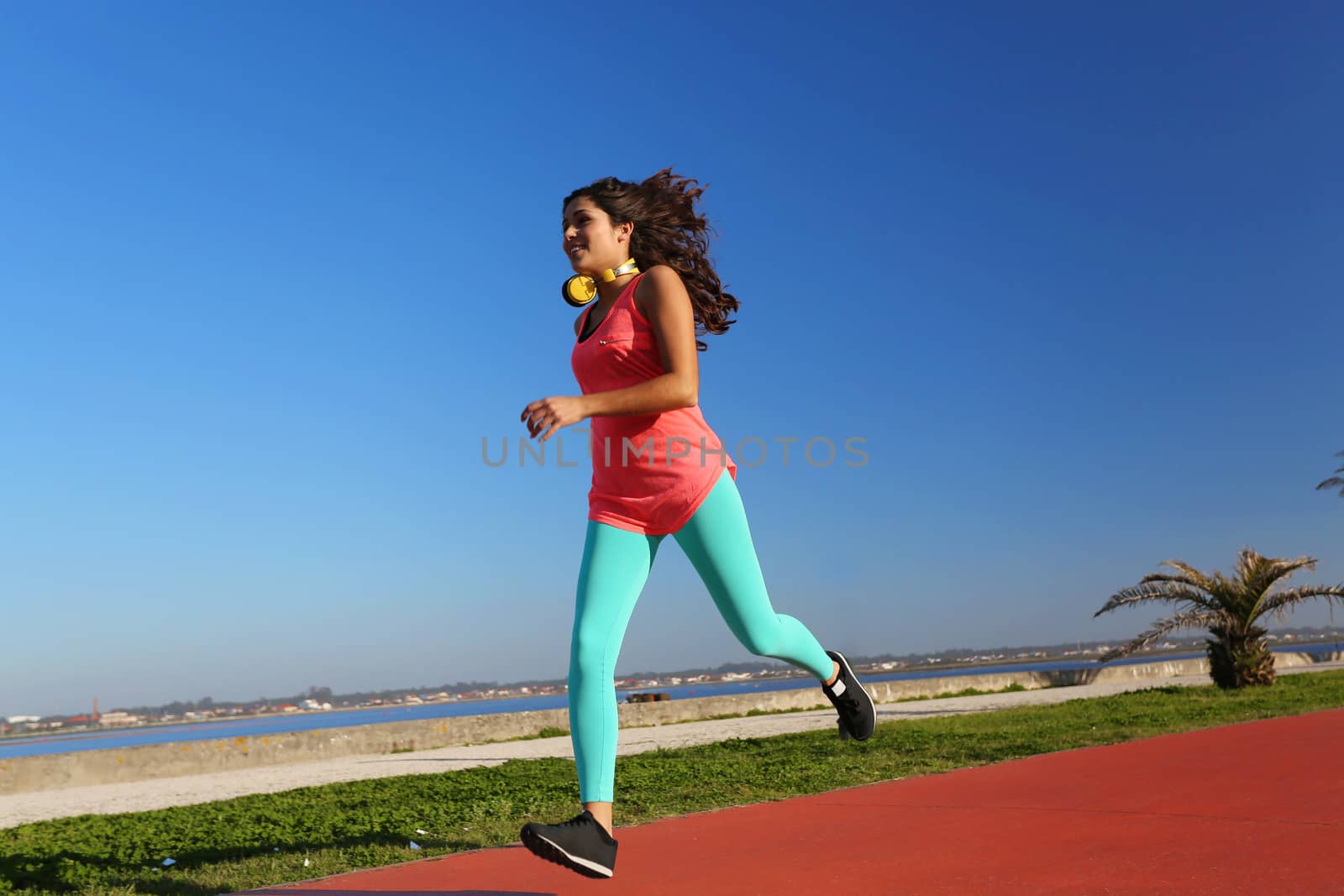 Fit woman running in the city park