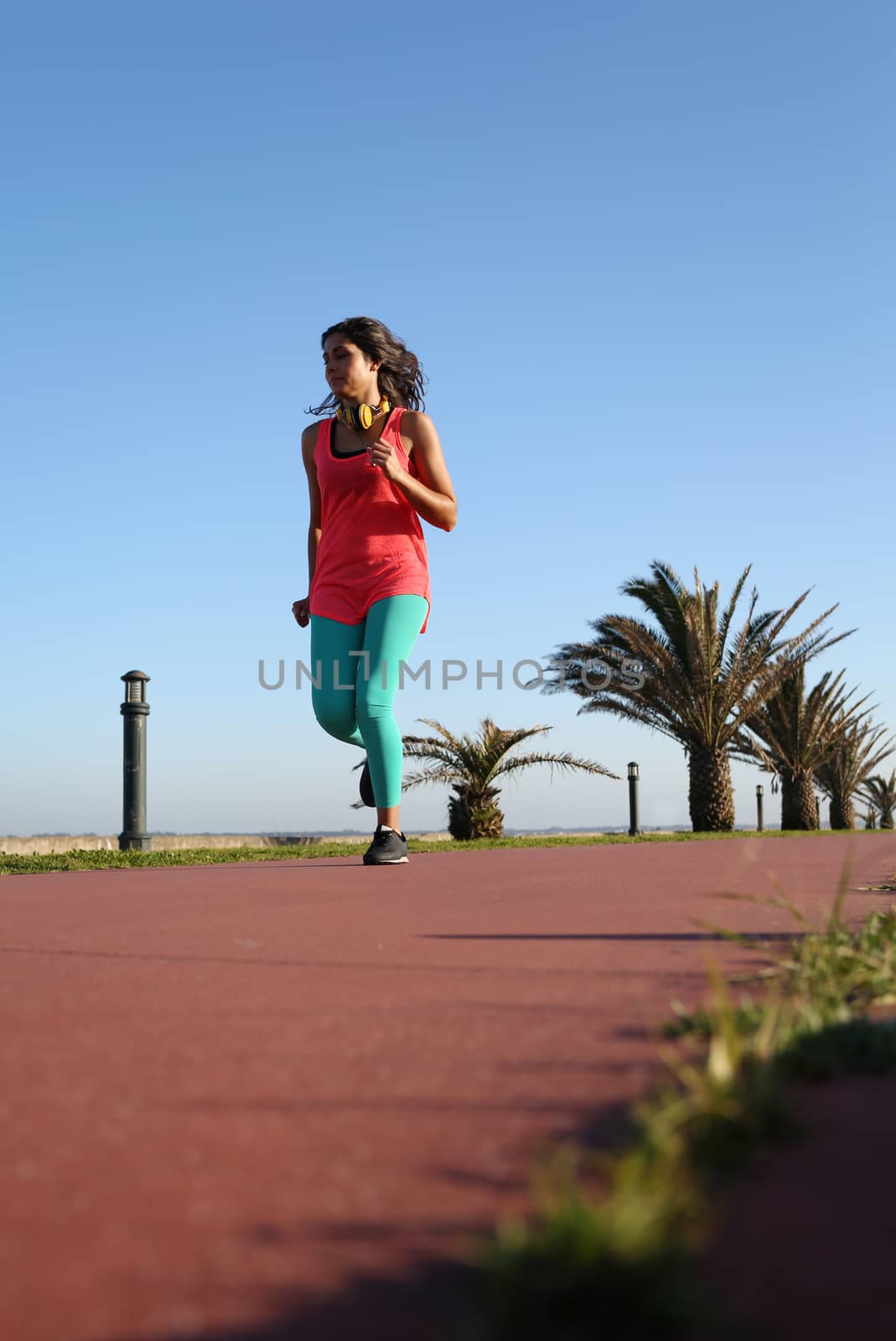 Fit woman running in the city park