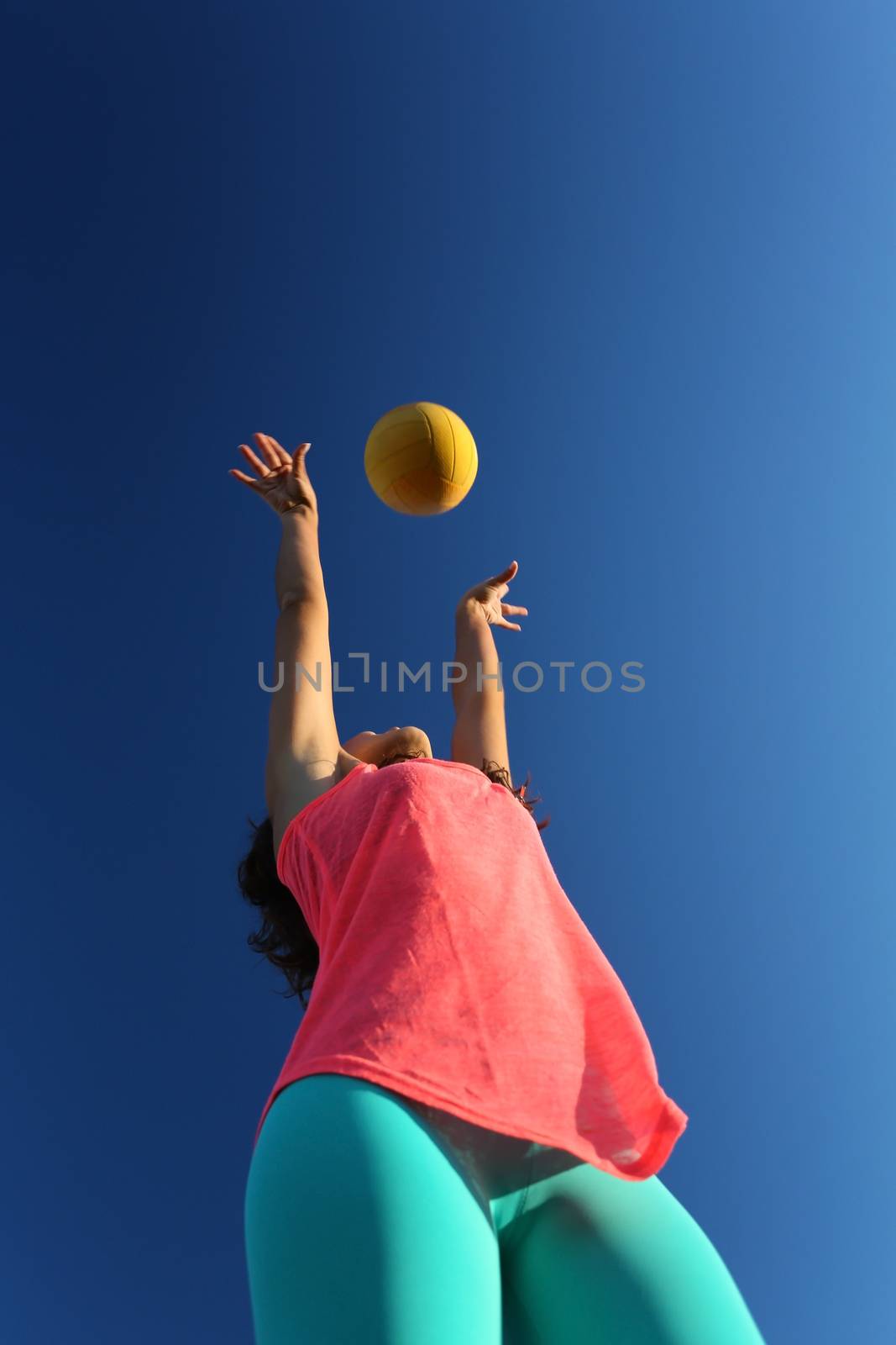 Woman playing with a ball in the city park