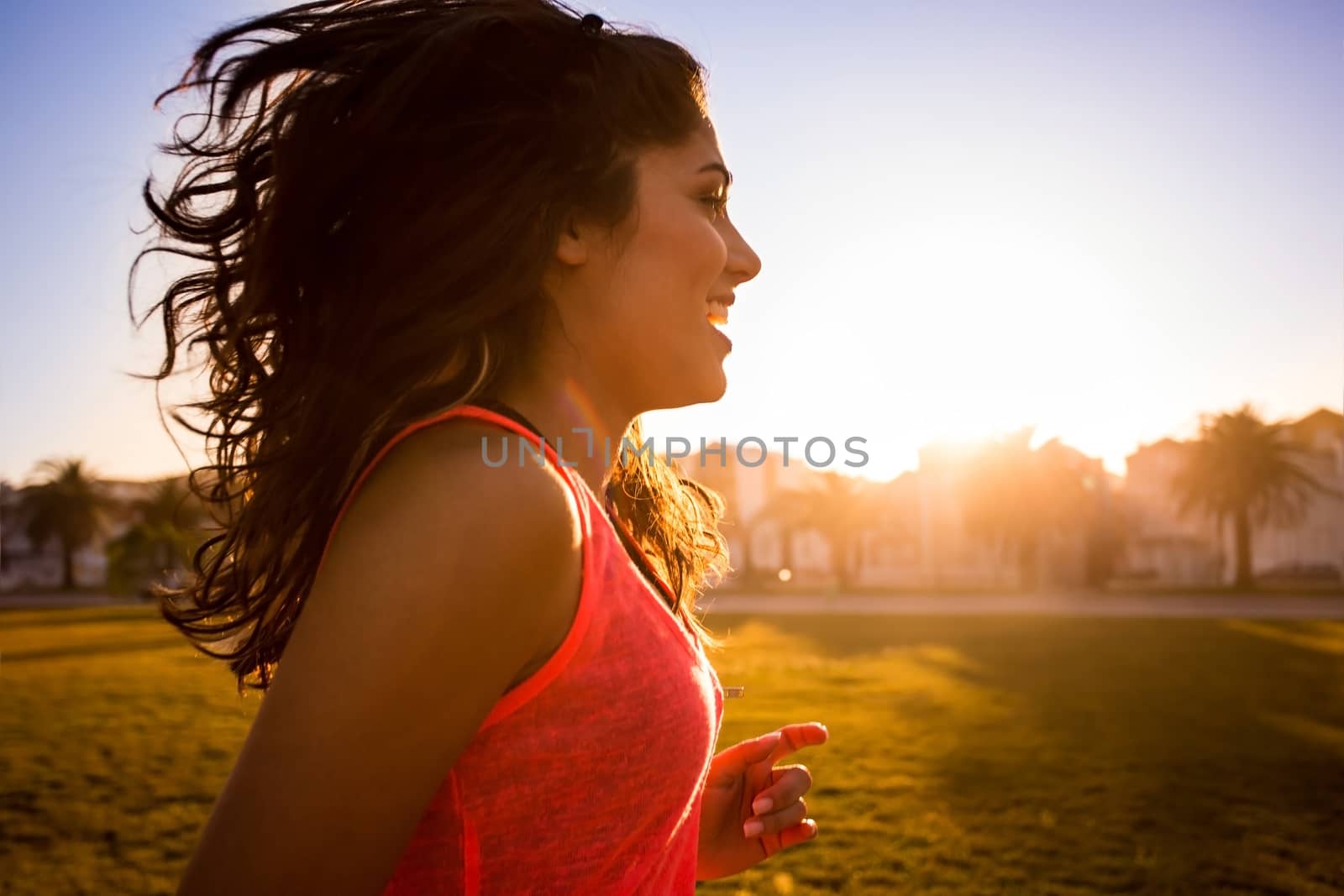 Woman running in the city park by jolopes