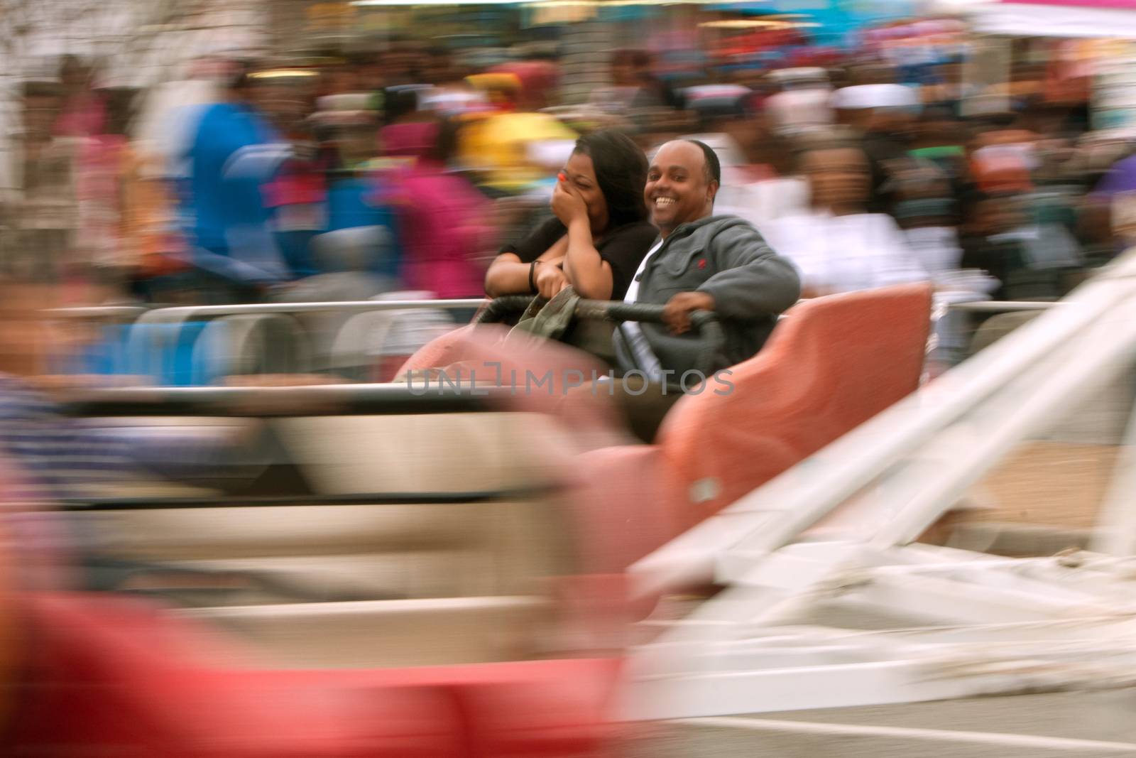 Atlanta, GA, USA - March 15, 2014:  A couple laughs while riding a fast-moving carnival ride at the annual Atlanta Fair.