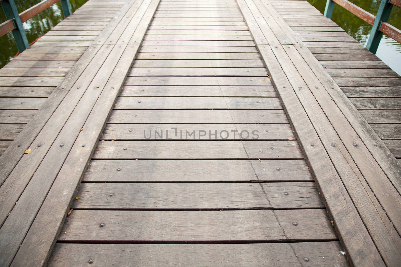 Long wooden bridge ahead. For the car and walk across the pool.