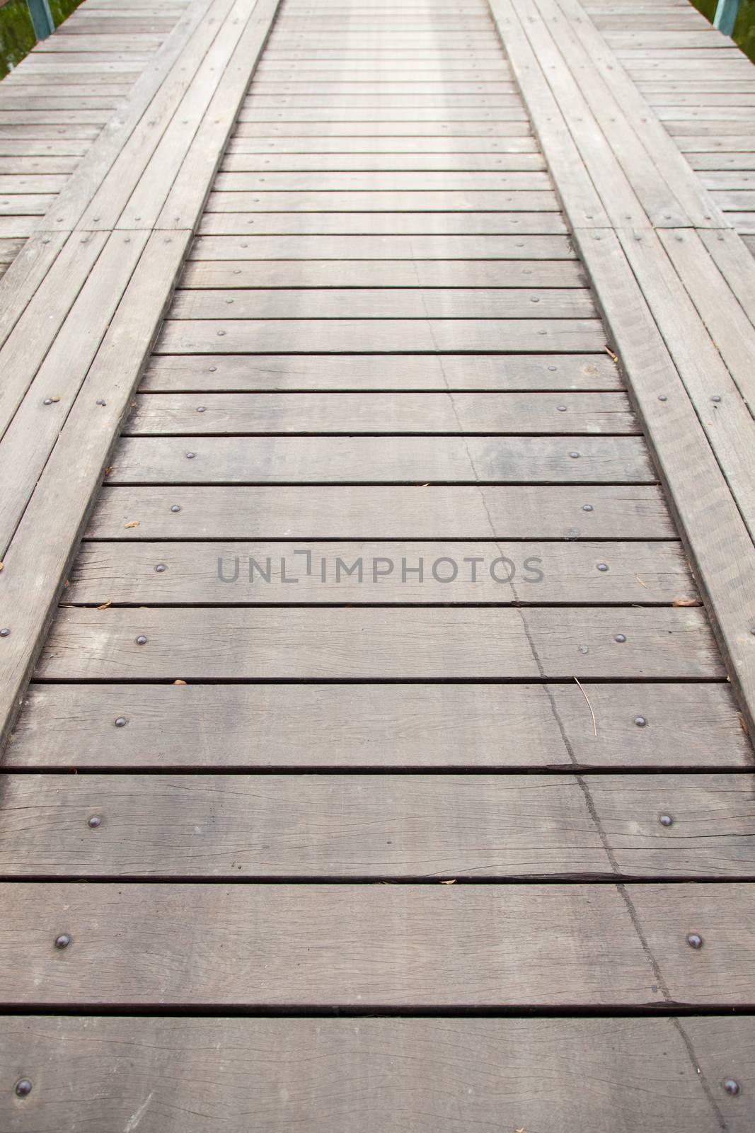 Long wooden bridge ahead. For the car and walk across the pool.