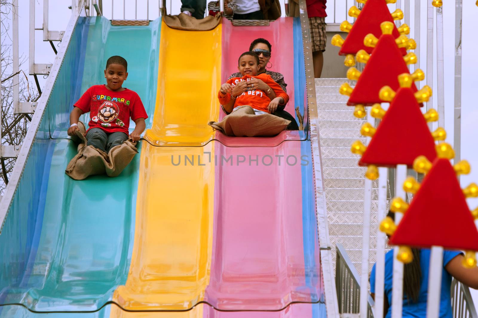Atlanta, GA, USA - March 15, 2014:  A family slides down the fun slide at the annual Atlanta Fair.