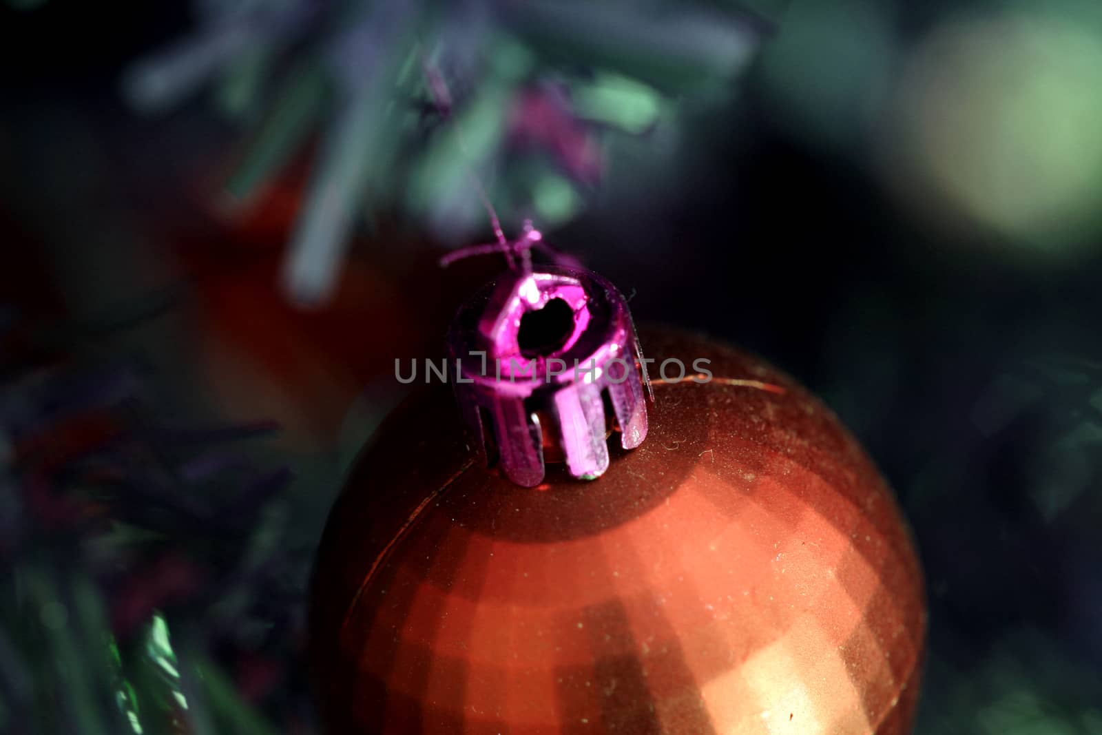 Close up of Christmas ornaments on tree.
