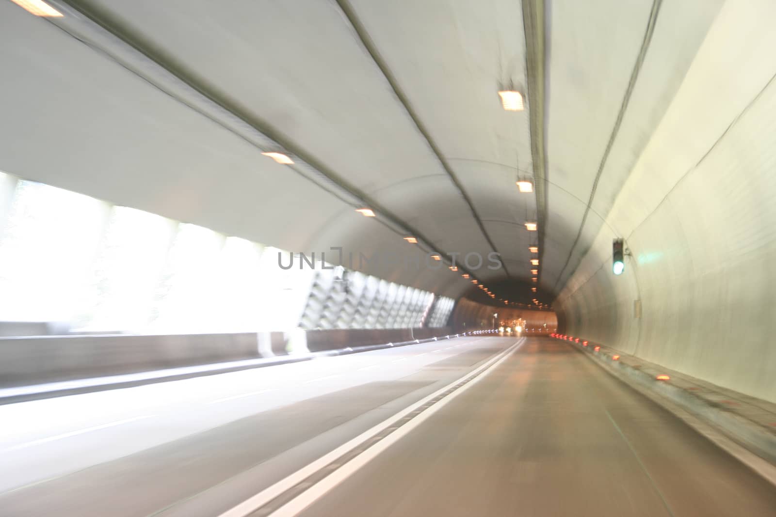 Car lights trails in a tunnel