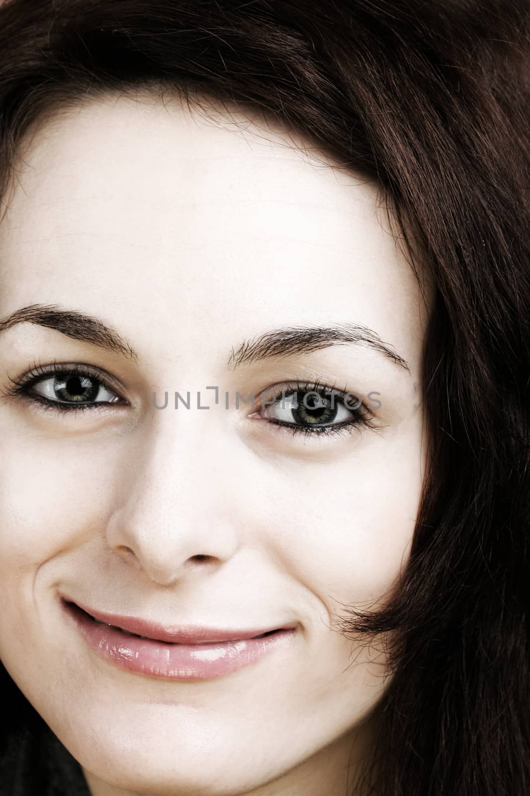 Portrait of a happy beautiful woman with green eyes.