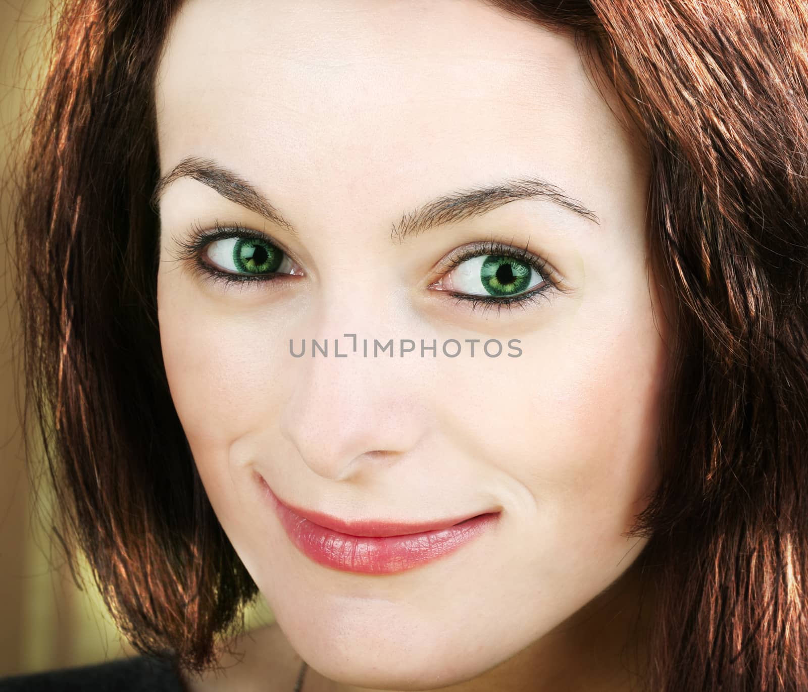 Portrait of a happy beautiful woman with green eyes.