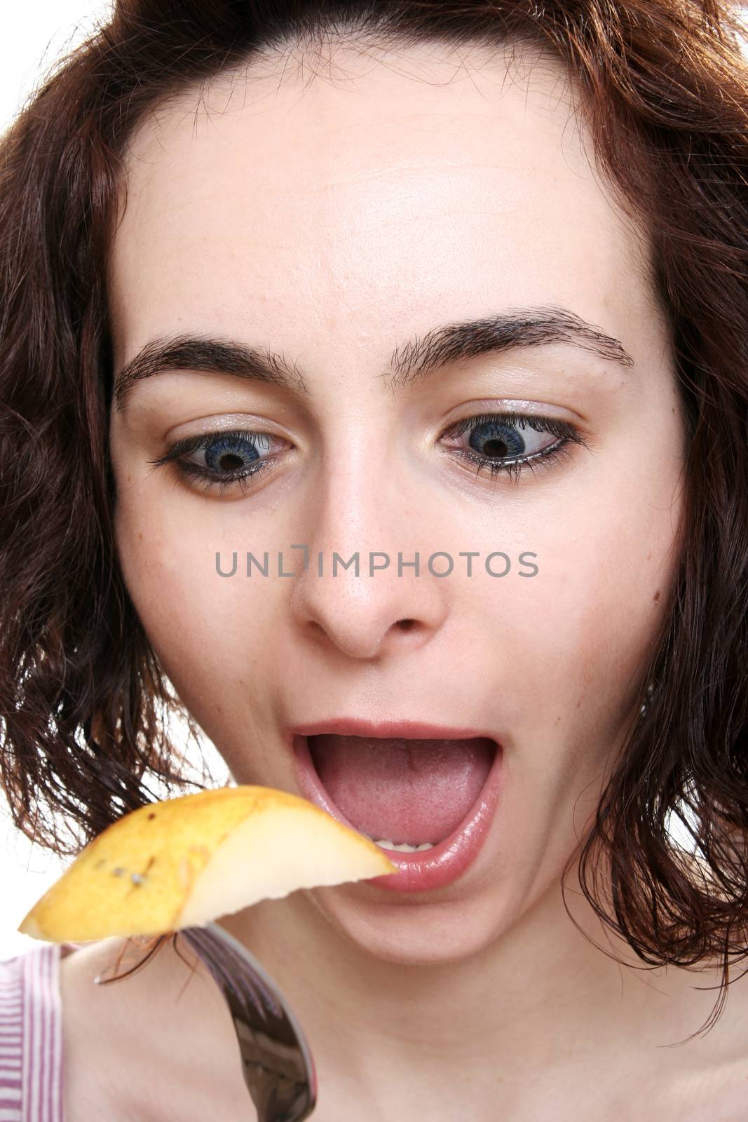 Woman eating tasty pear with forch.