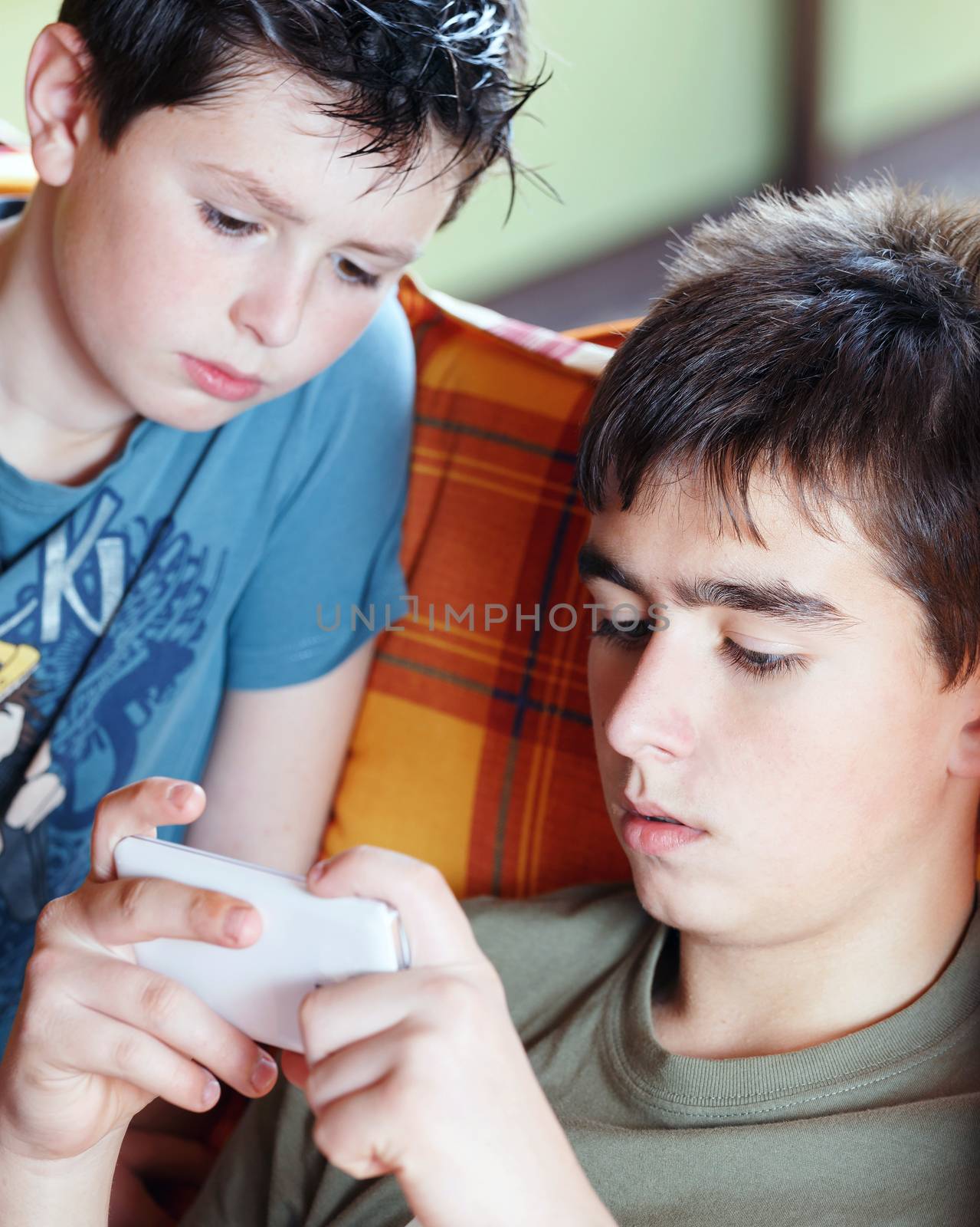 Teenager boys playing on smartphone, outdoor by artush