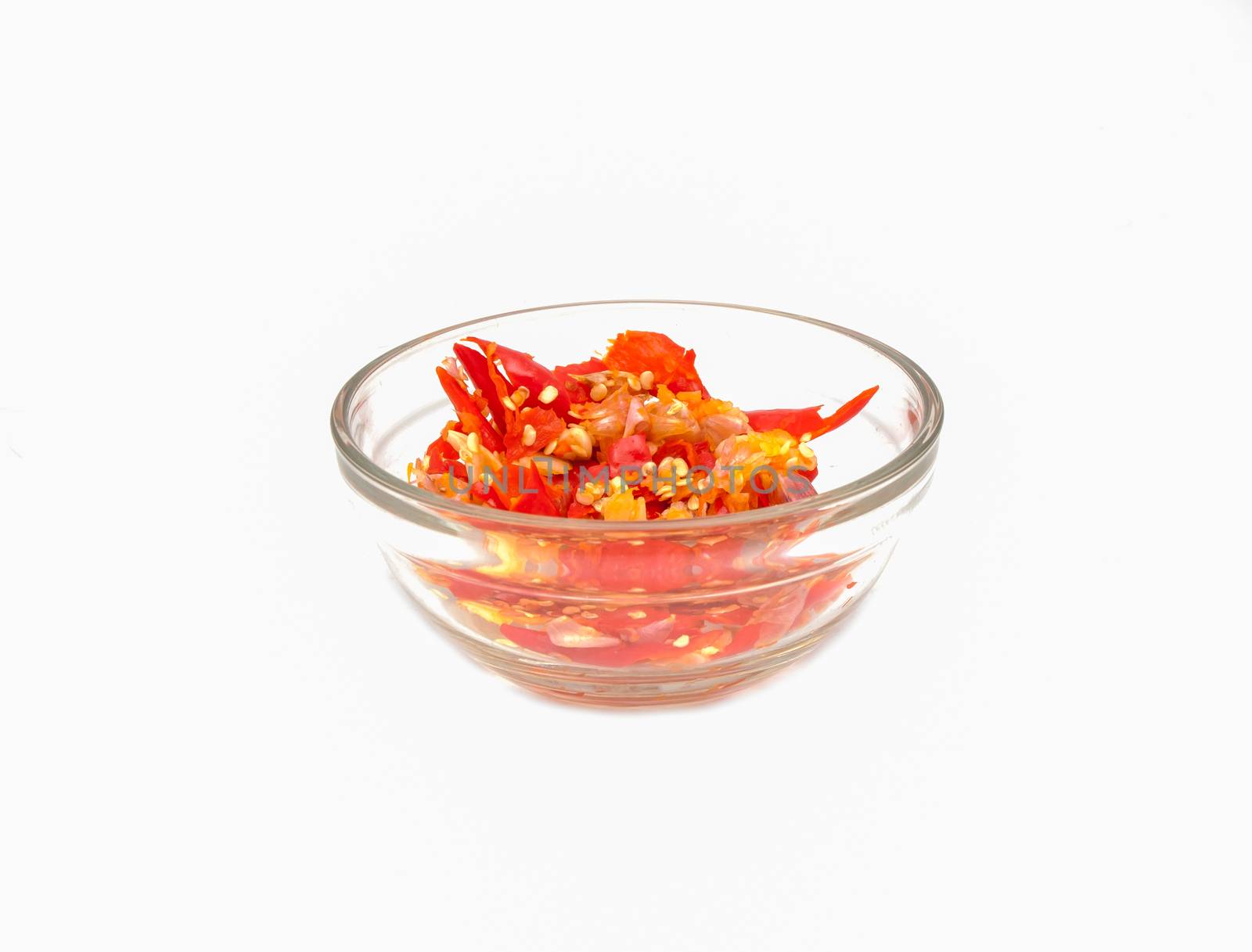 Crush chilli in the cup on white background