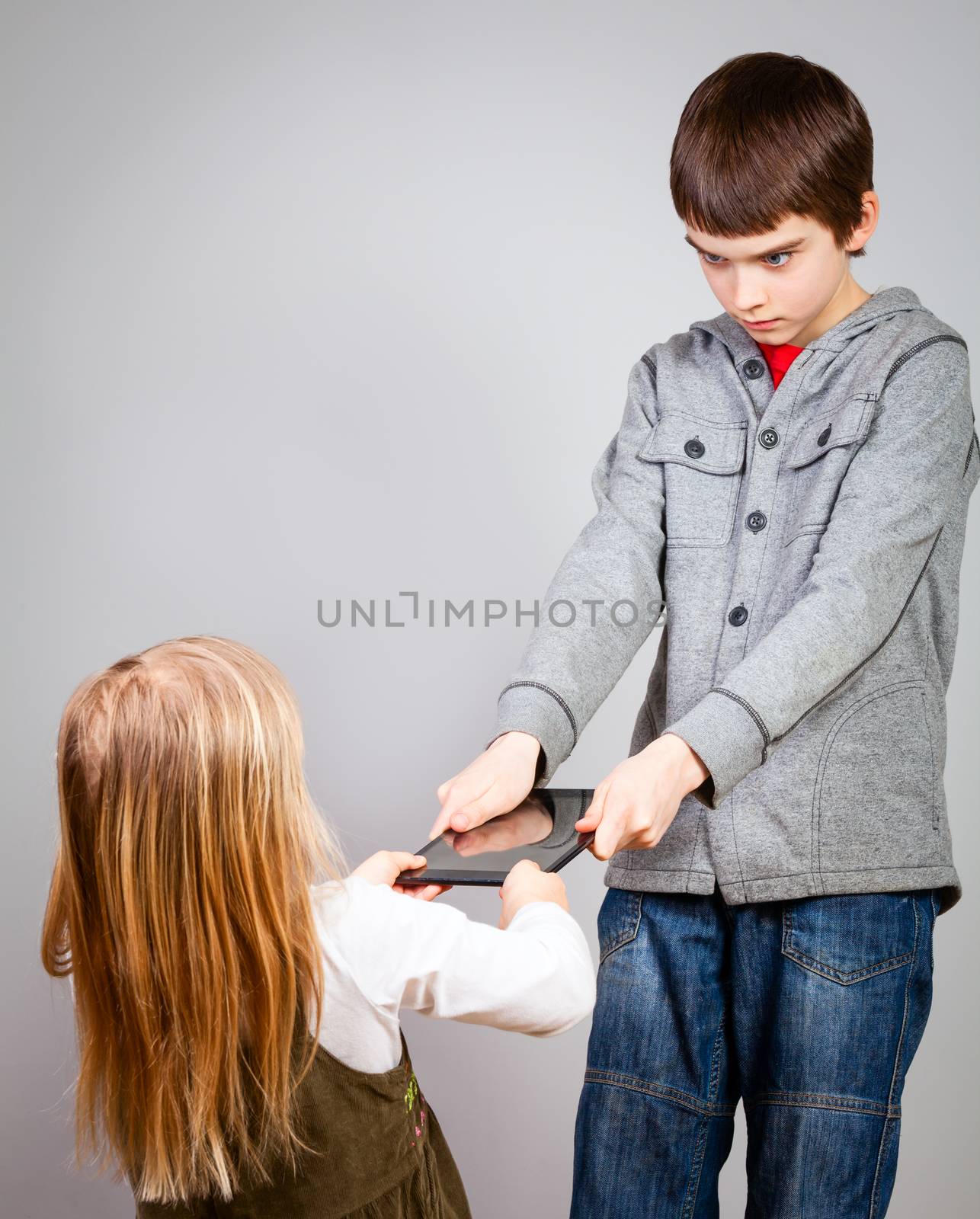 Children fight for tablet computer by naumoid