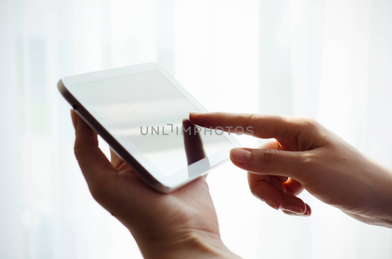 Woman hand working with tablet and pointing touchscreen