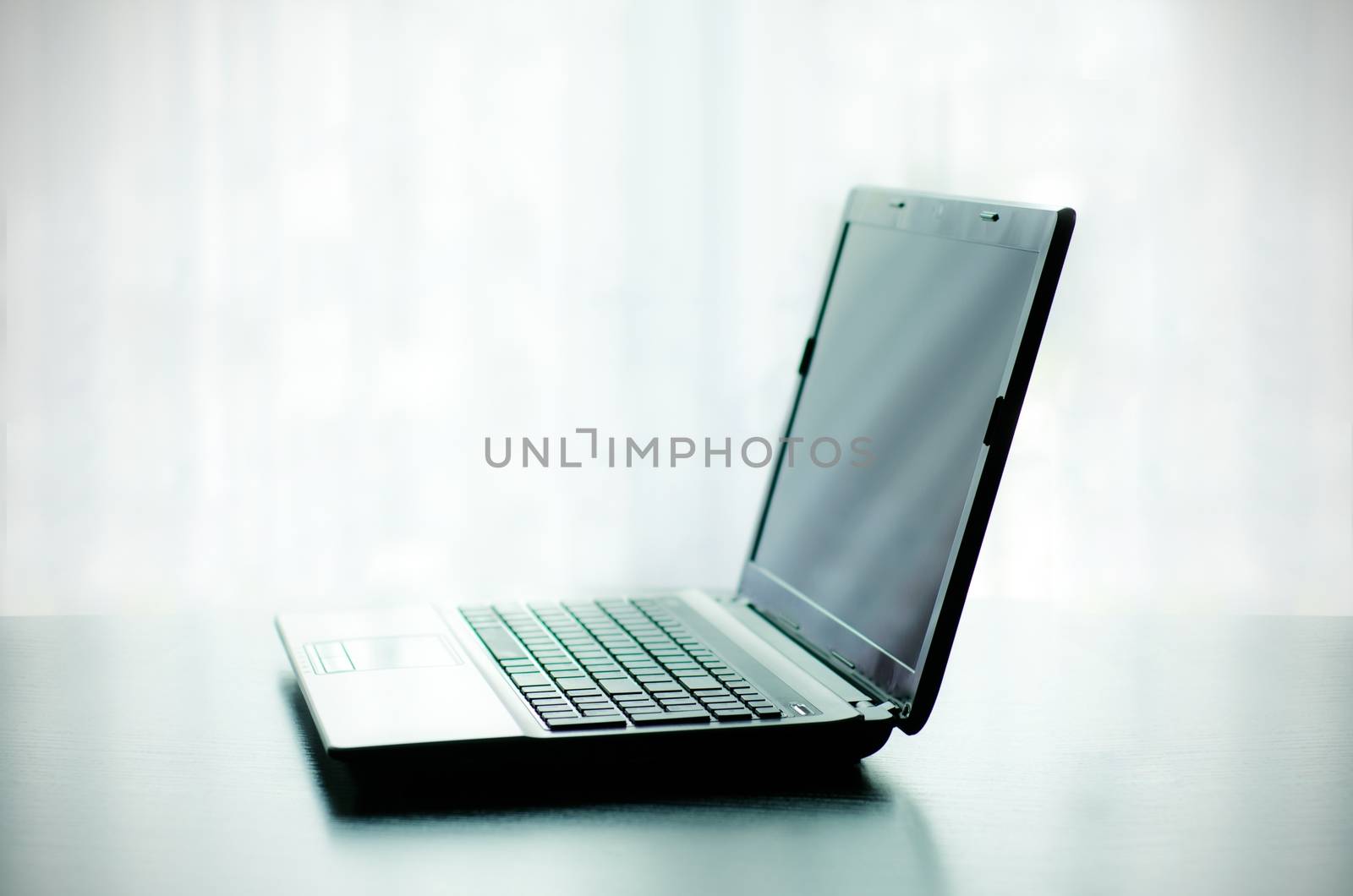 Modern laptop on desk by simpson33