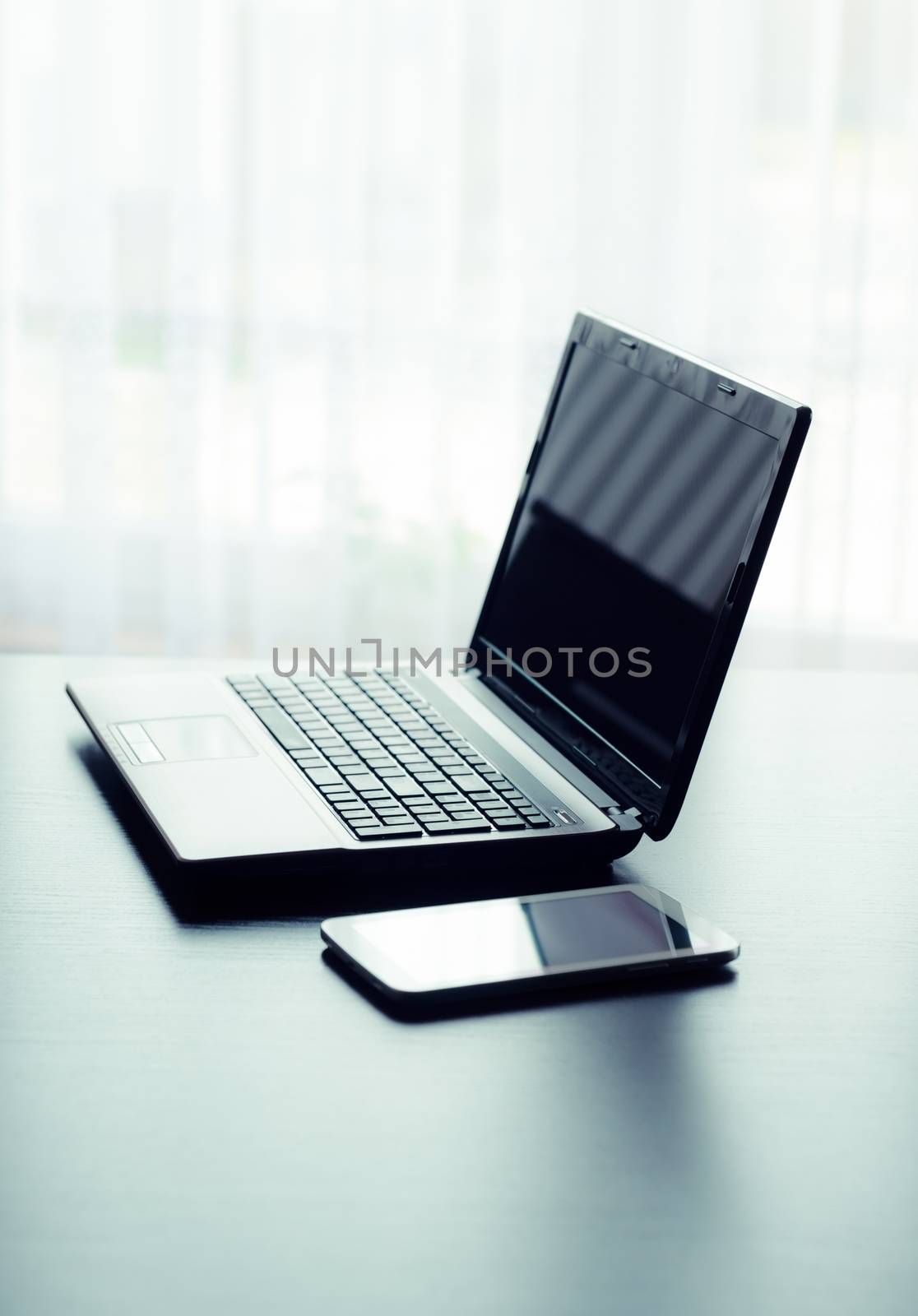 Modern laptop and tablet in office by simpson33