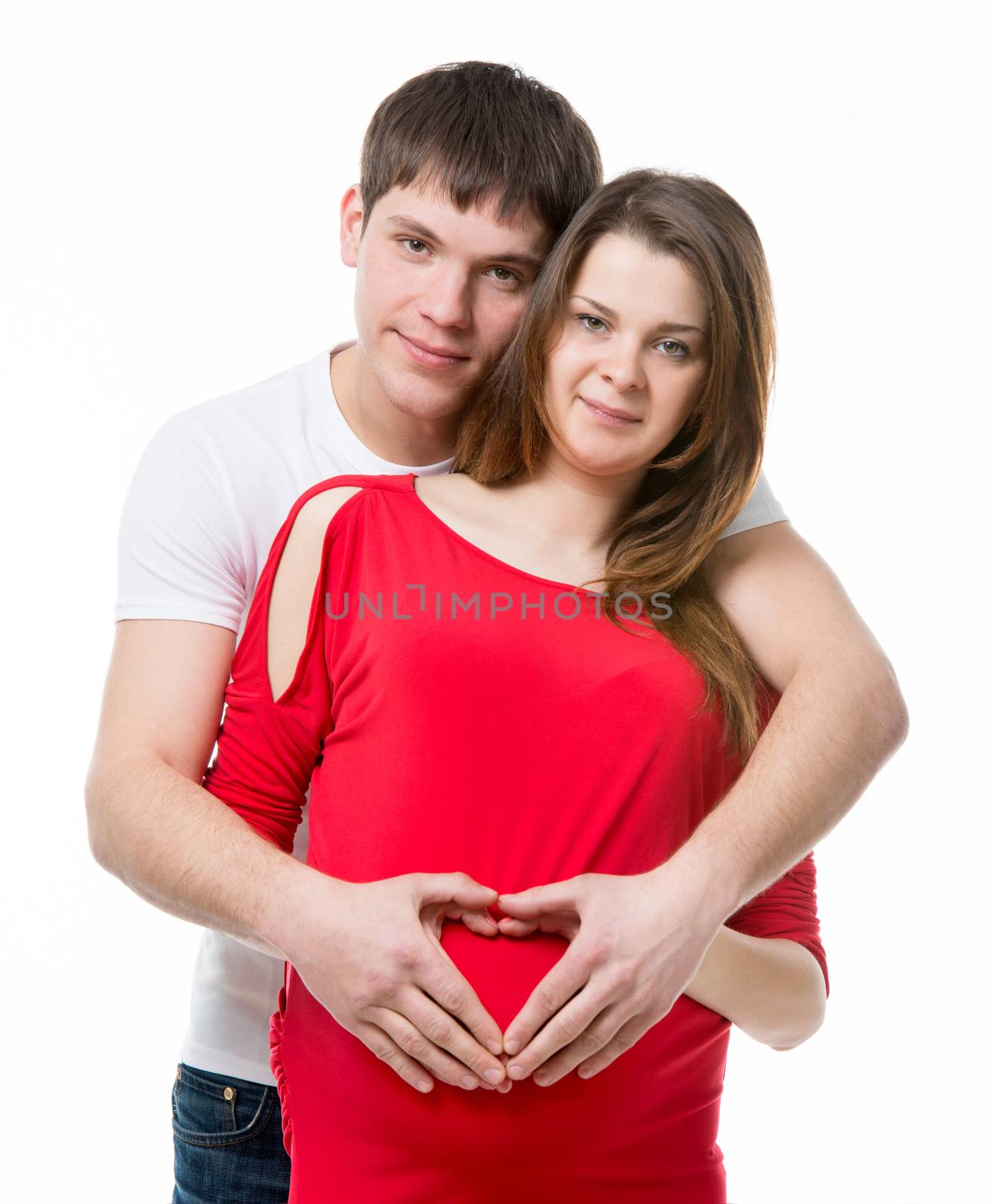 husband and pregnant wife holding hands in heart shape