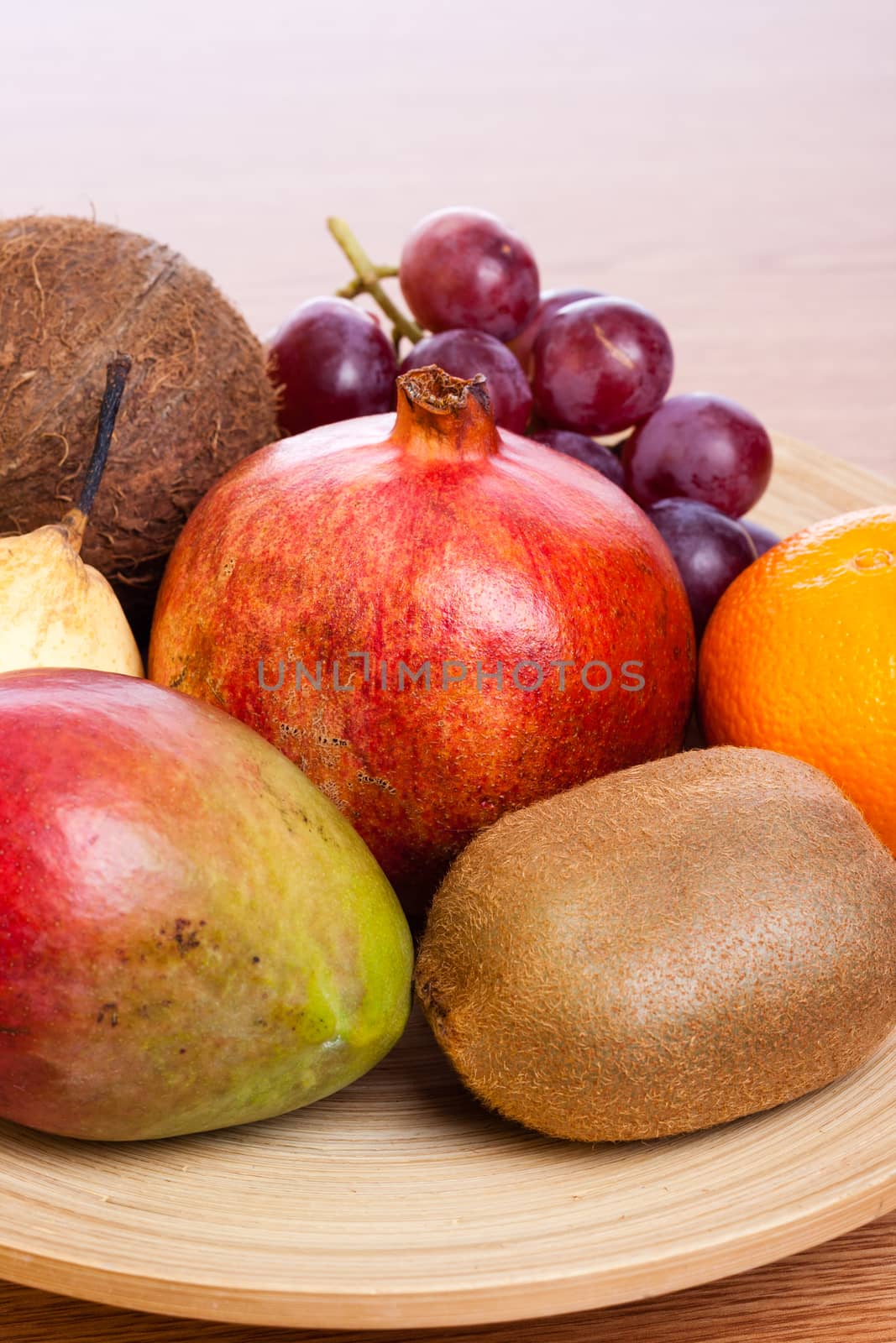 bunch of exotic fruits on a wooden plate