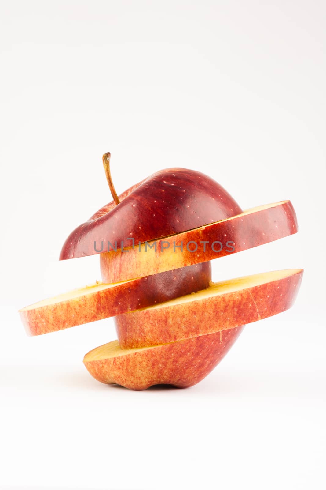 creativeli sliced red apple on white apple