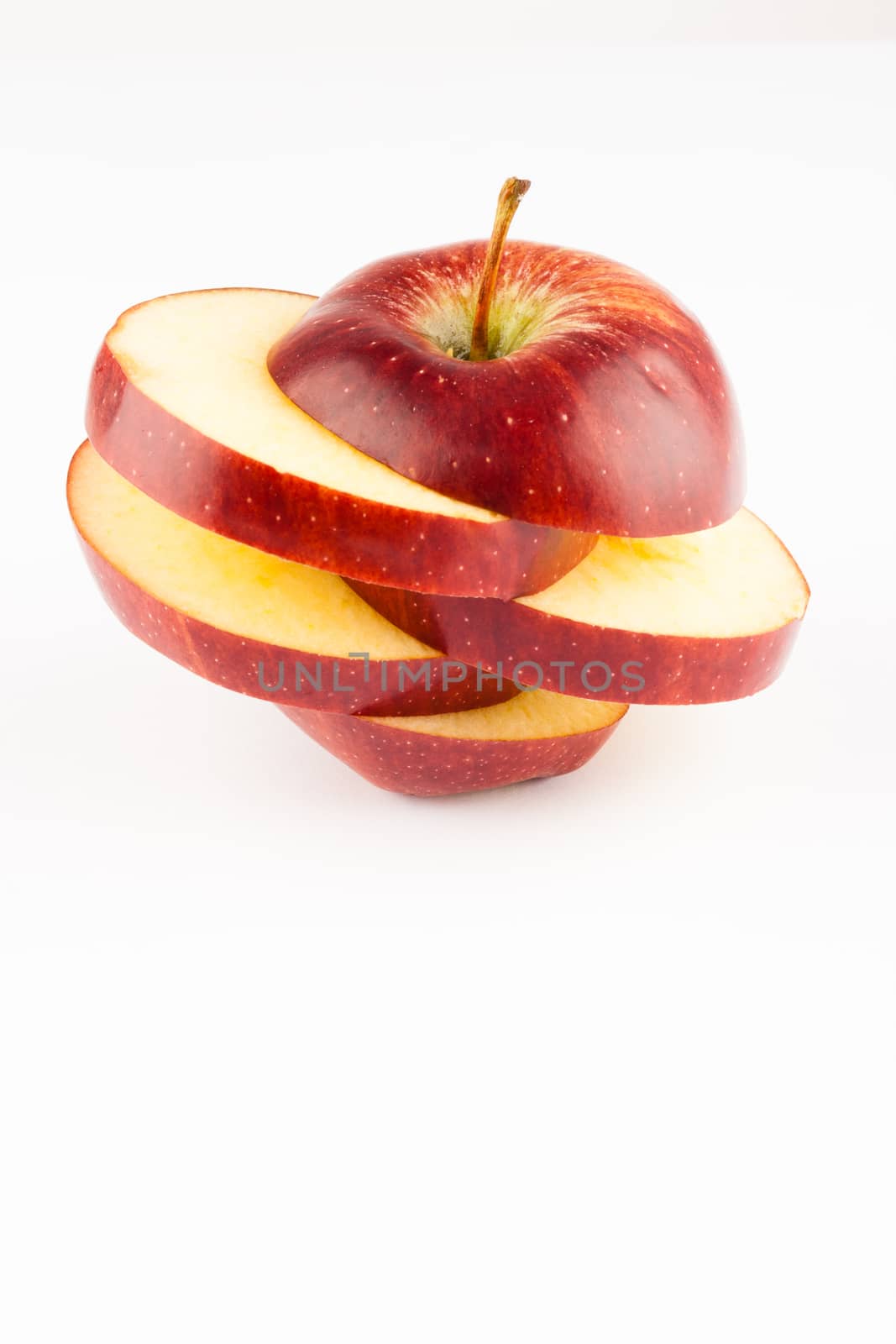 creativeli sliced red apple on white apple