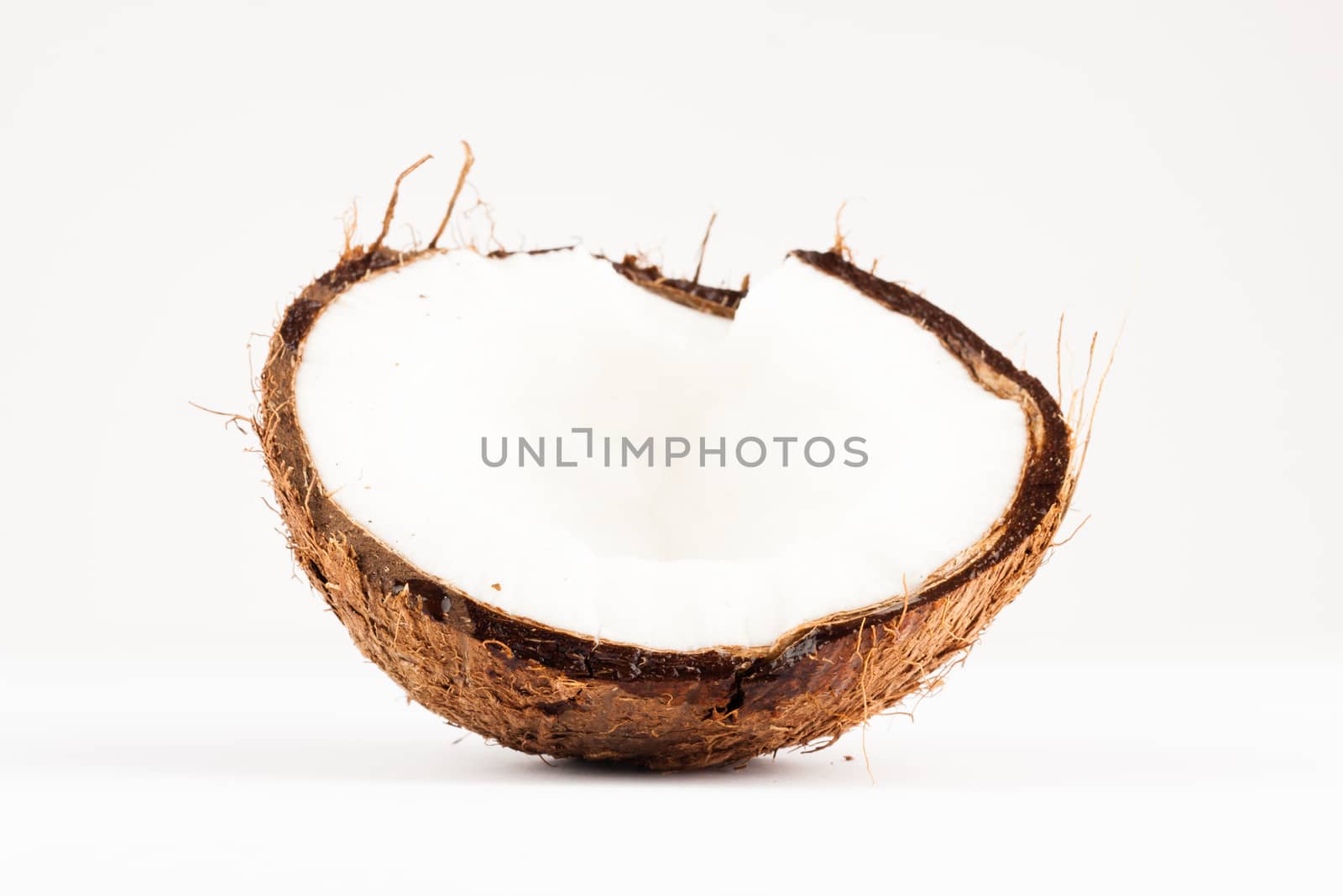 fresh brown coconut closeup on white background
