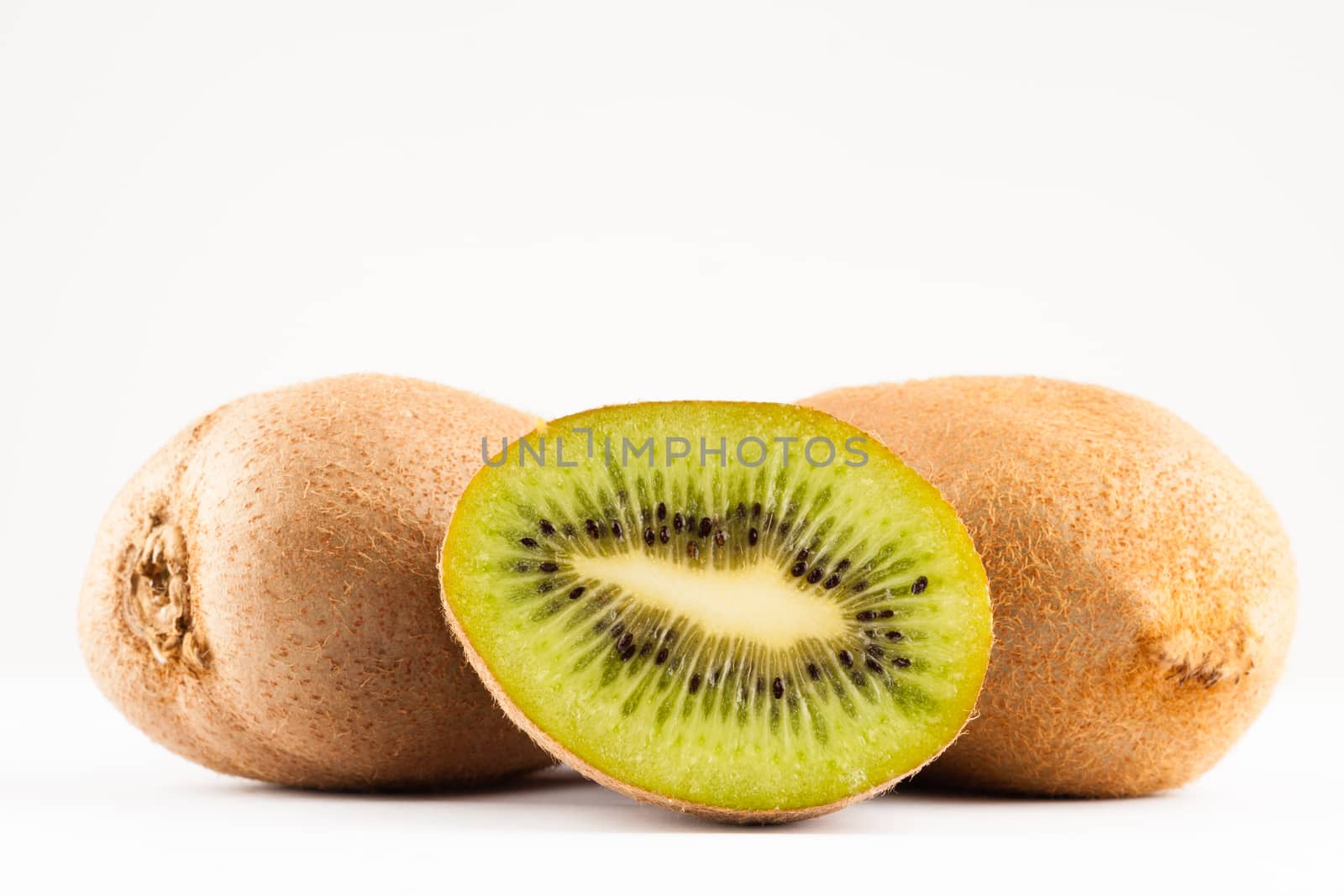 kiwi fruits whole and sliced on white background