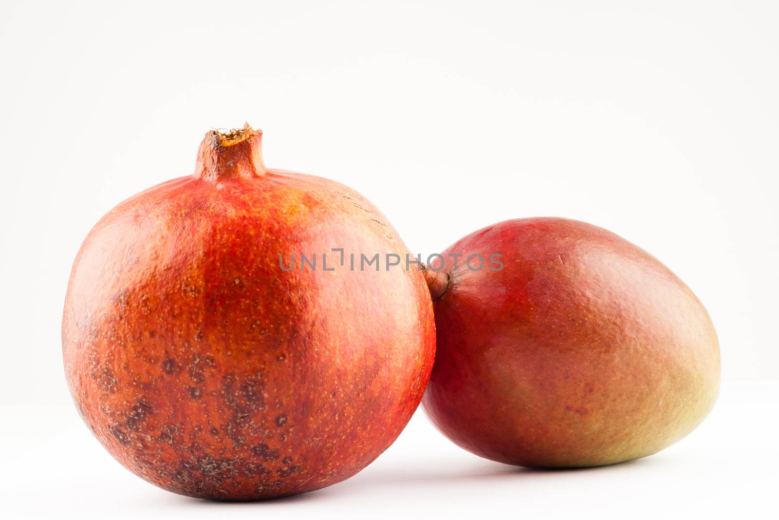 two ripe exotic fruits on white background