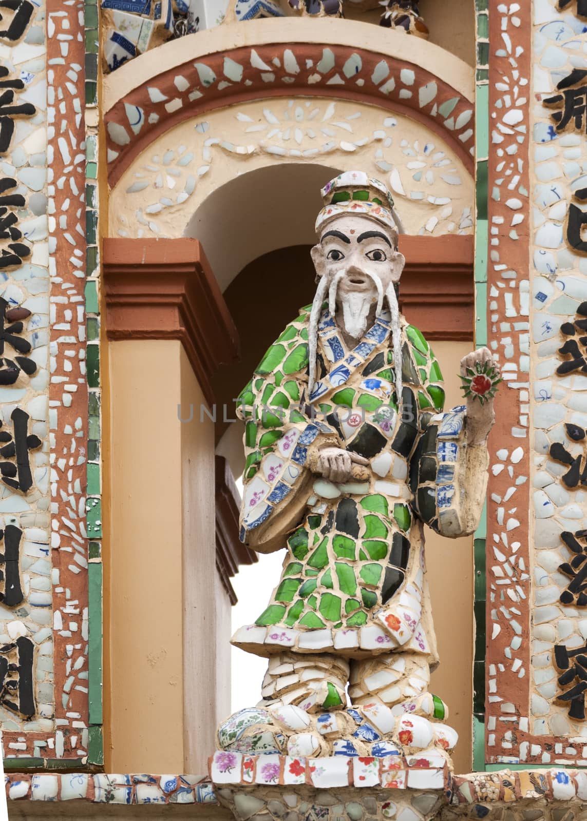 Statue at gate to Buddhist Vinh Trang Pagoda, Vietnam. by Claudine