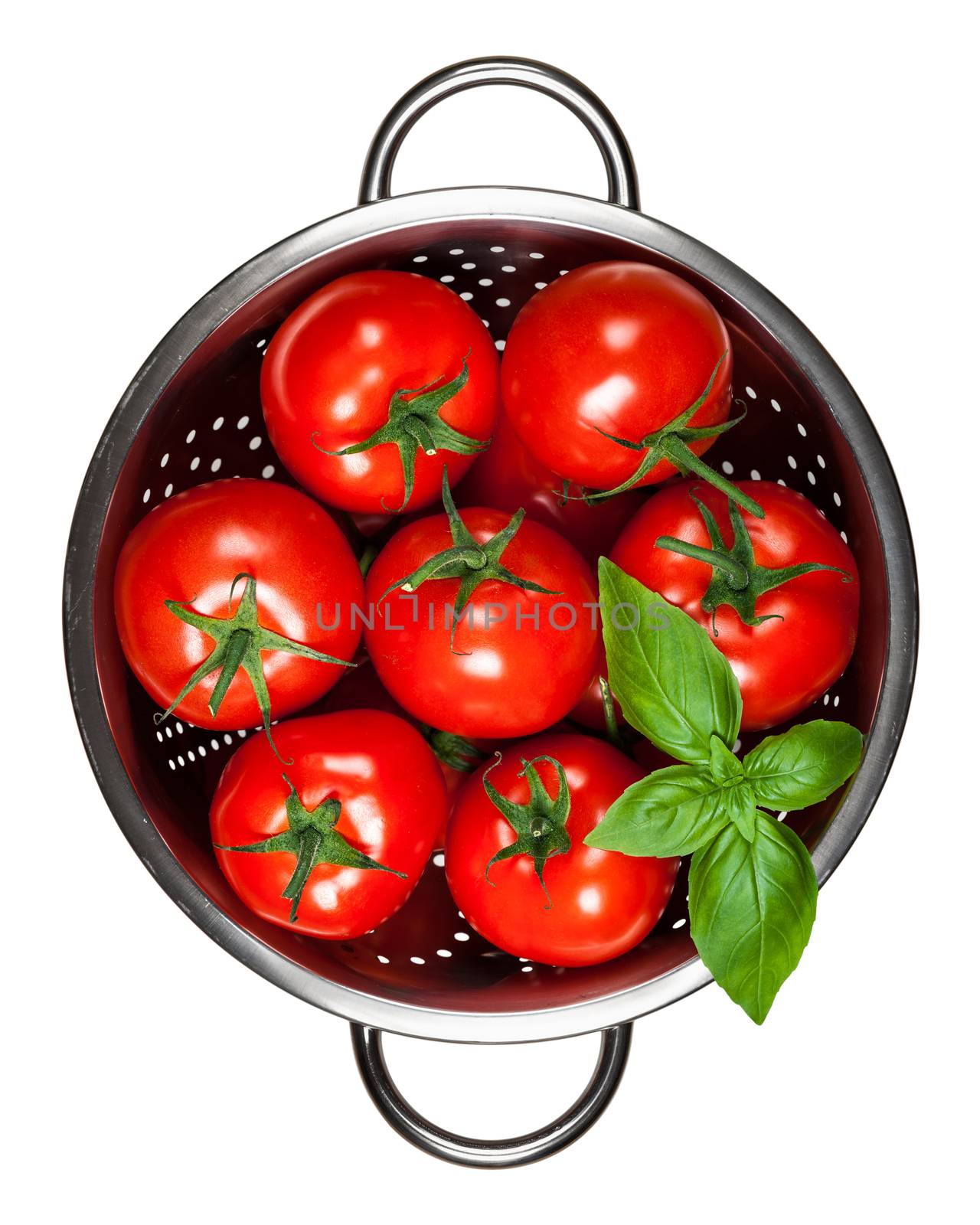 Tomatoes with basil in colander isolated on white background. Top view
