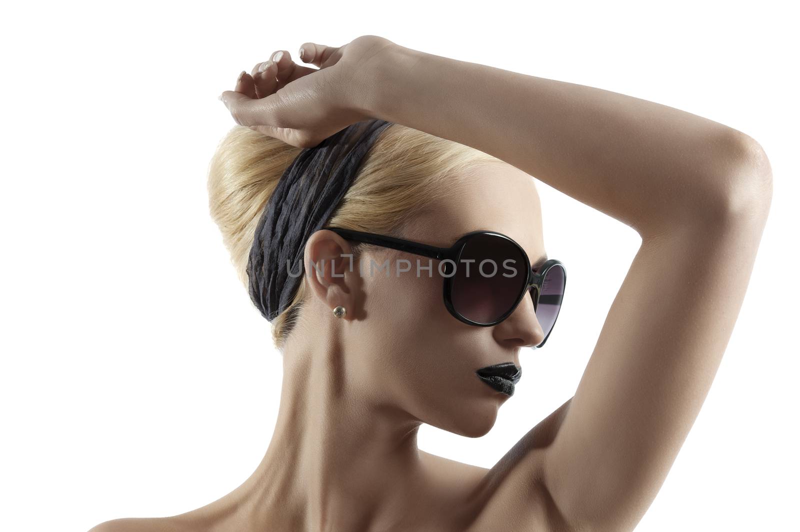 fashion portrait of young blond woman with hair style black lips and wearing sunglasses posing against white background