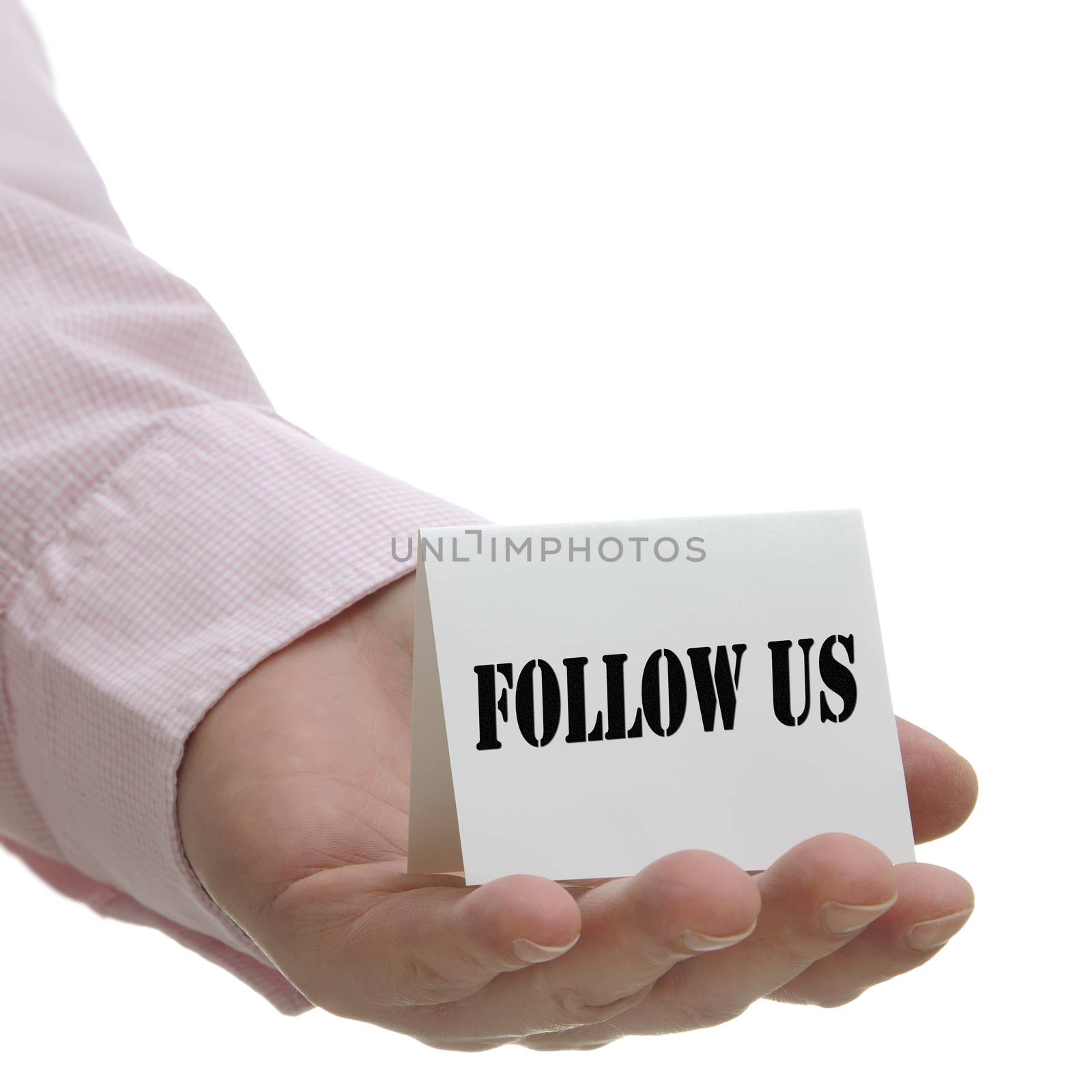 Business man holding follow us sign on hand