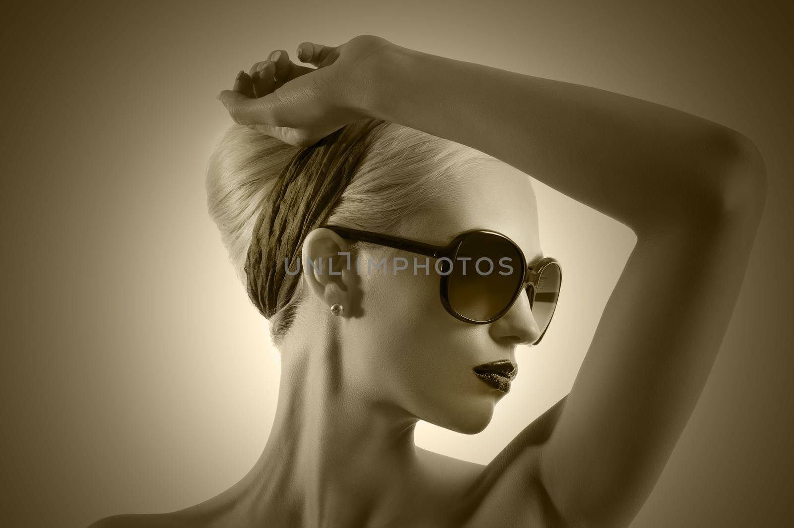 fashion shot of blond girl with sunglasses posing against white by fotoCD