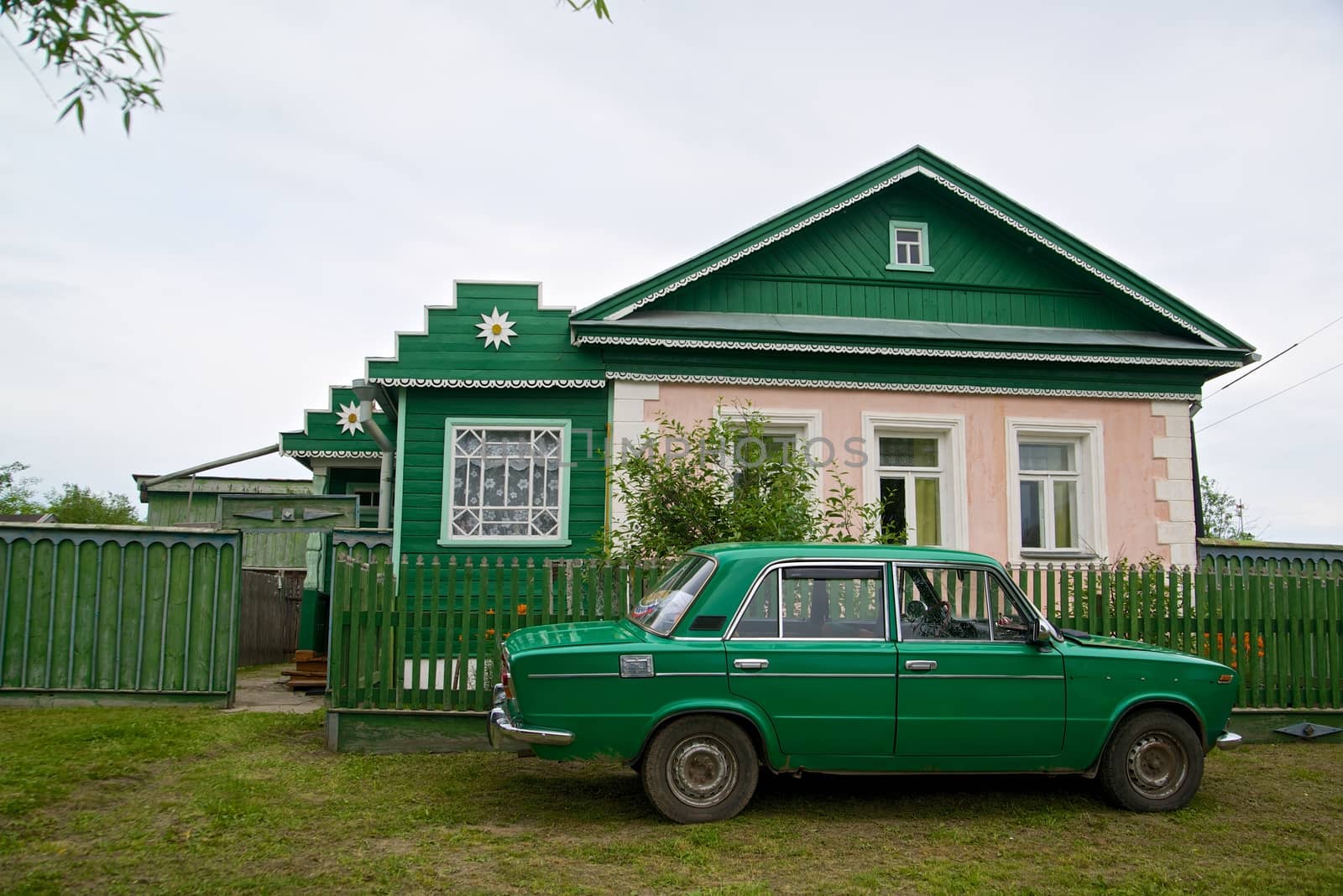 The picture of typical old-fashioned house on the roads of Russia