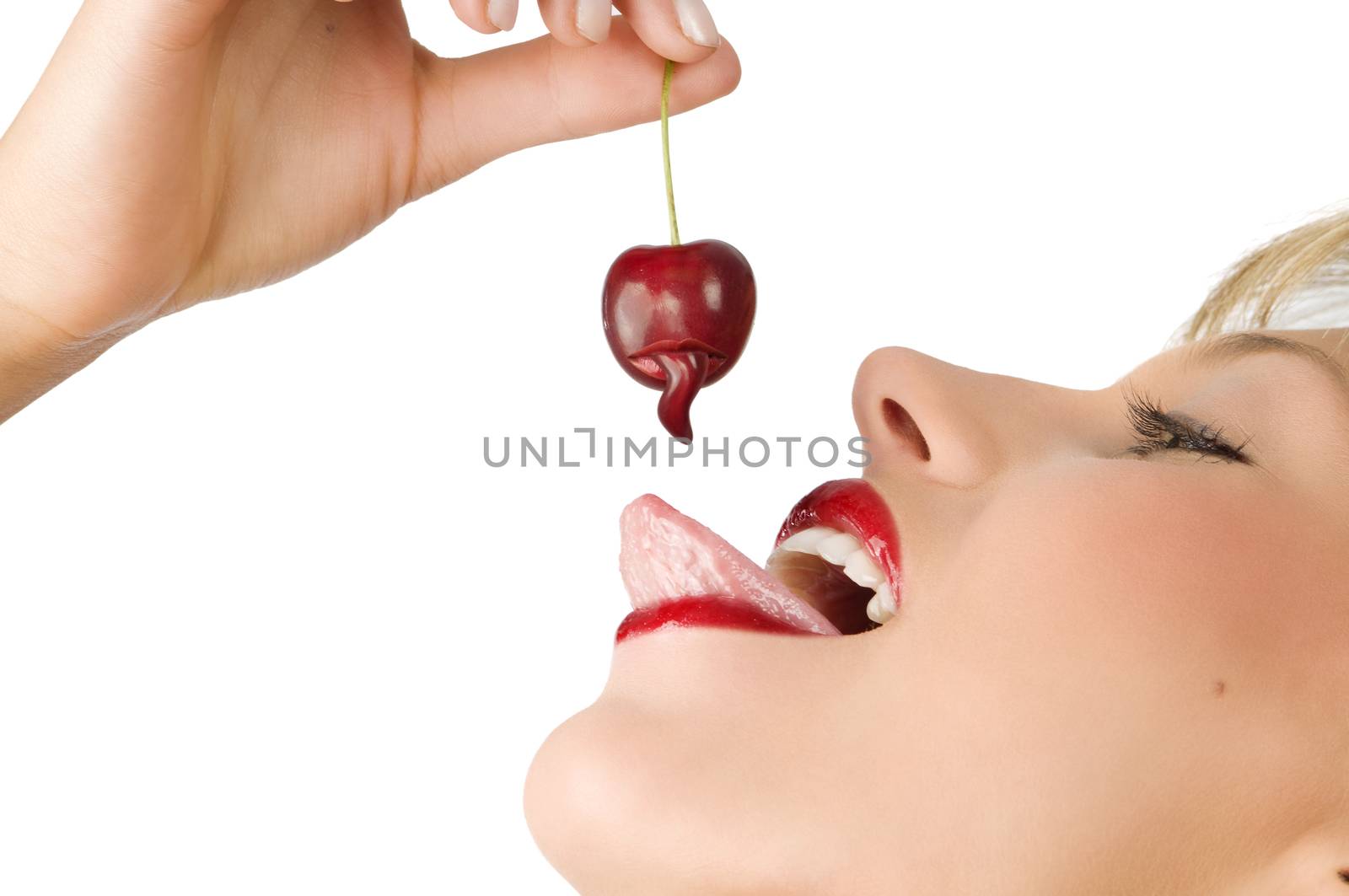 close up on of a sensual girl playing with her tongue with a cherry